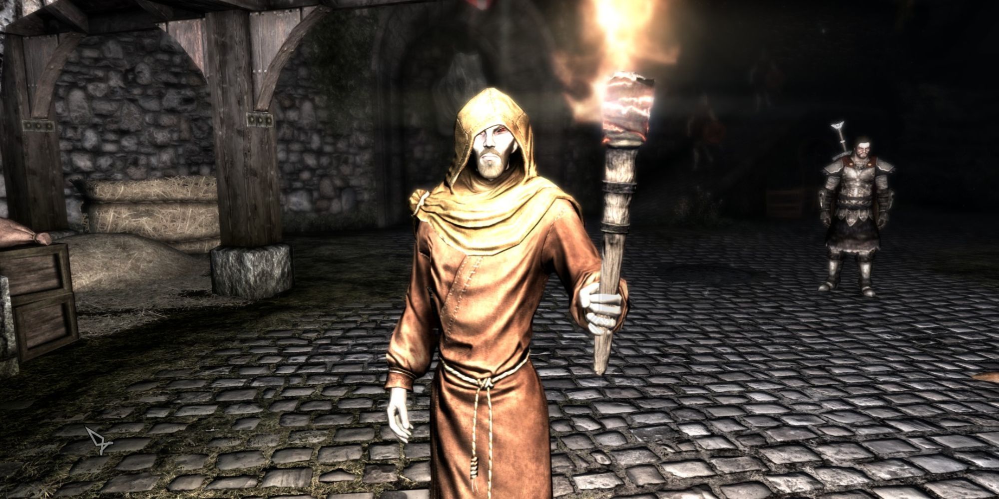 Erandur stands on cobblestone streets as he holds up a torch to see at night 