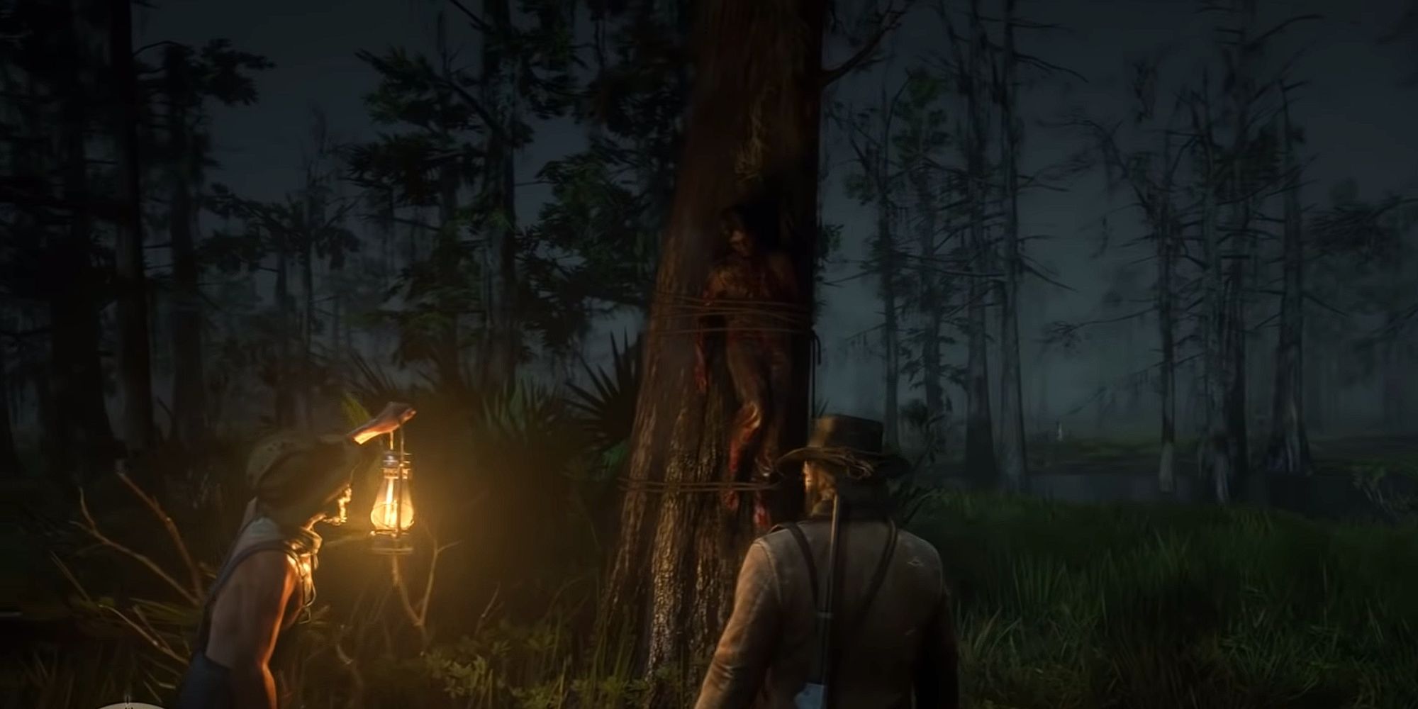 Arthur and the old man holding a lantern look up at a dead body tied to a tree at night
