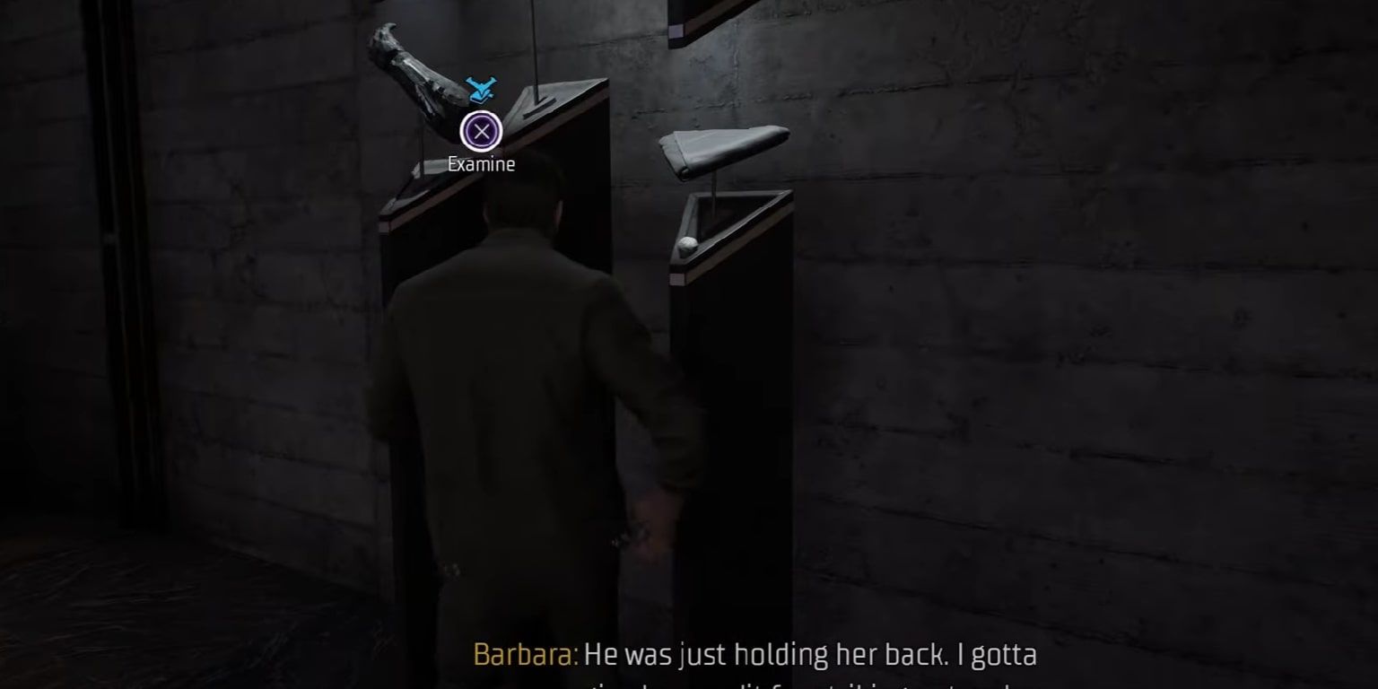 Screenshot of a player interacting with Batman's cowel and armor at the Belfry in Gotham Knights.