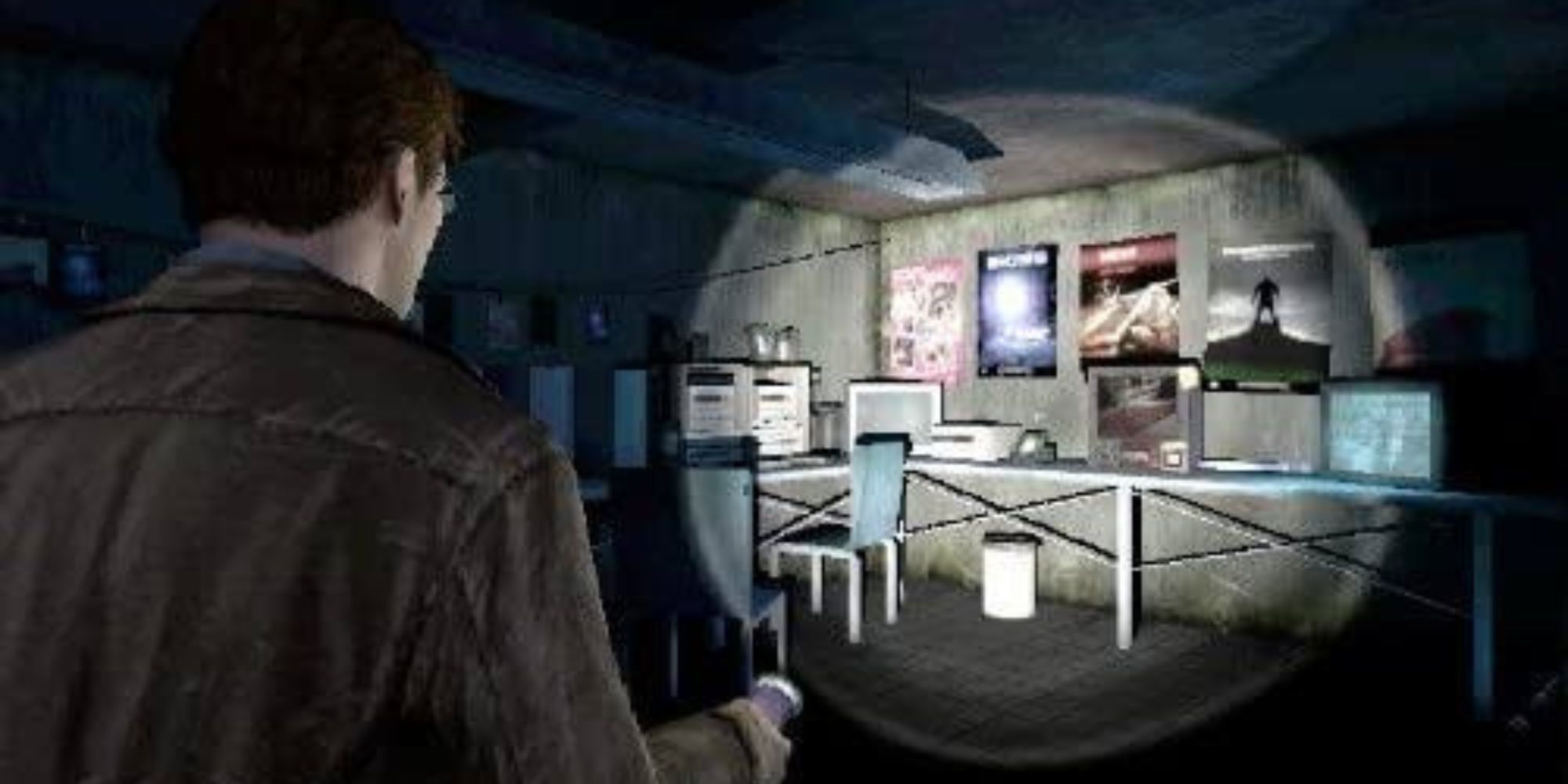Harry Mason investigates a dark room covered in posters in Silent Hill Shattered memories