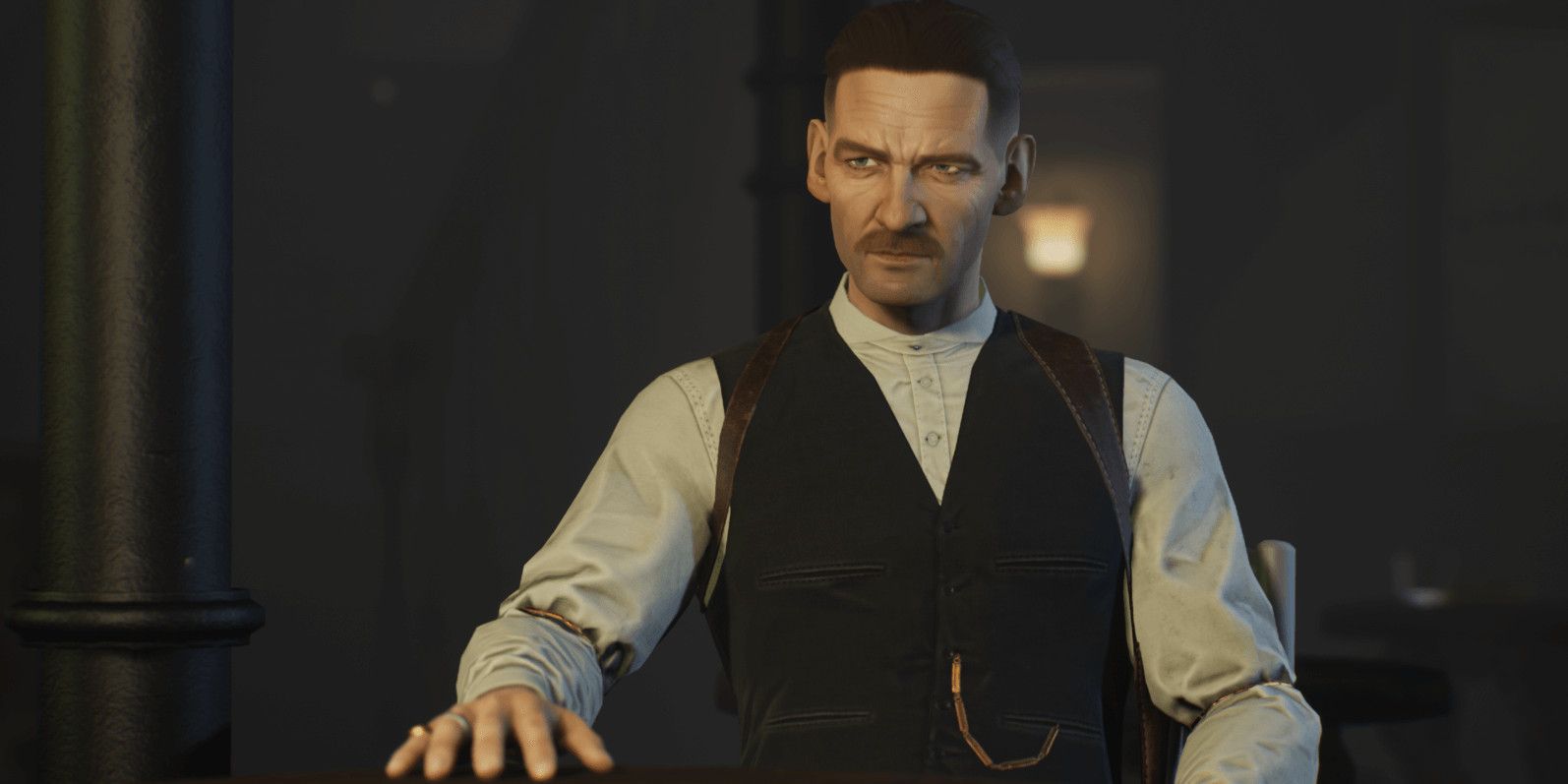 arthur shelby standing with his hand on a bar