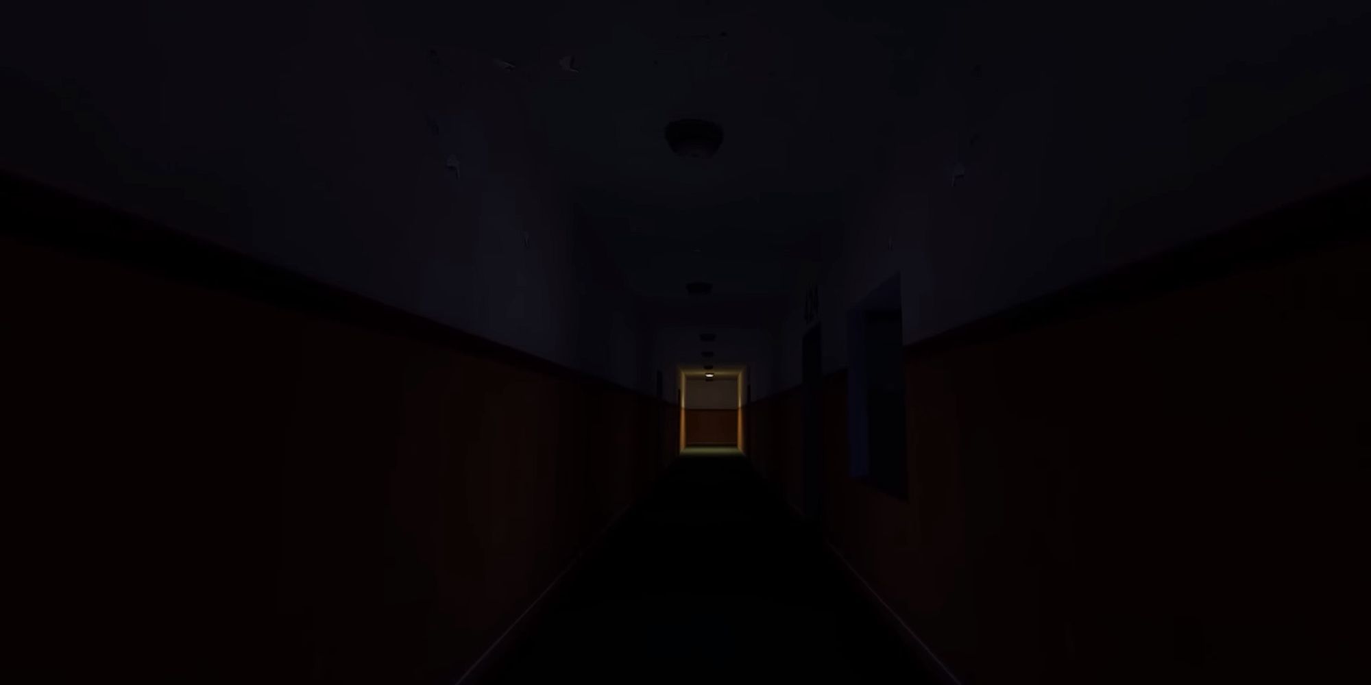 A single light burns at the end of a long, dark hallway
