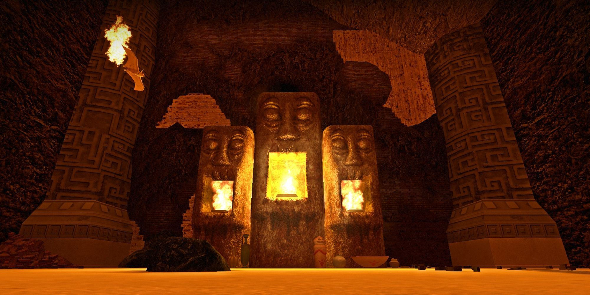 fire flows within the mouths of large head statues, while lava fills the floor in a cave