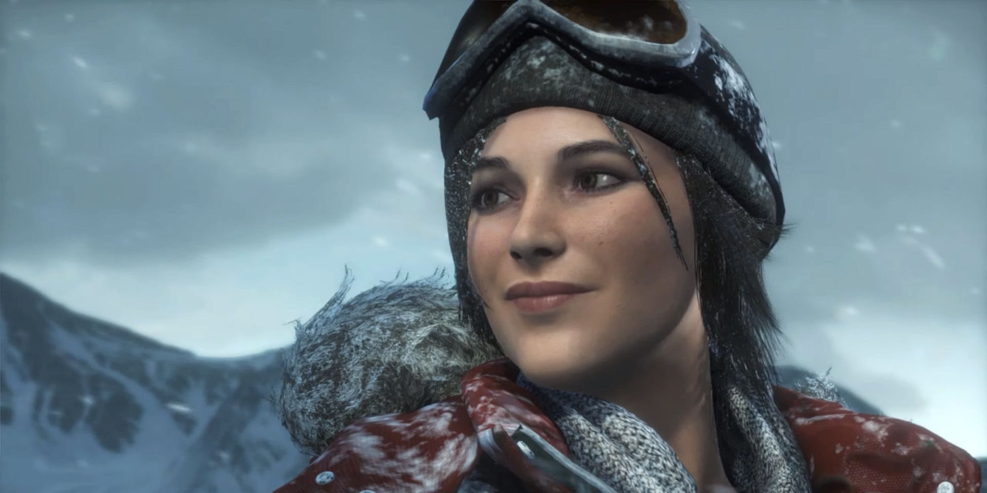 Lara Croft smiles as she stands on the summit of a snow mountain in winter gear