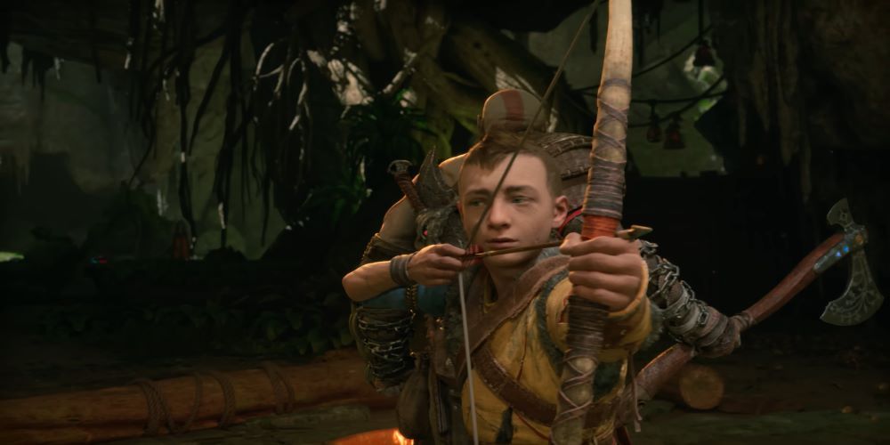 Atreus draws his bow while Kratos stands guard behind him.