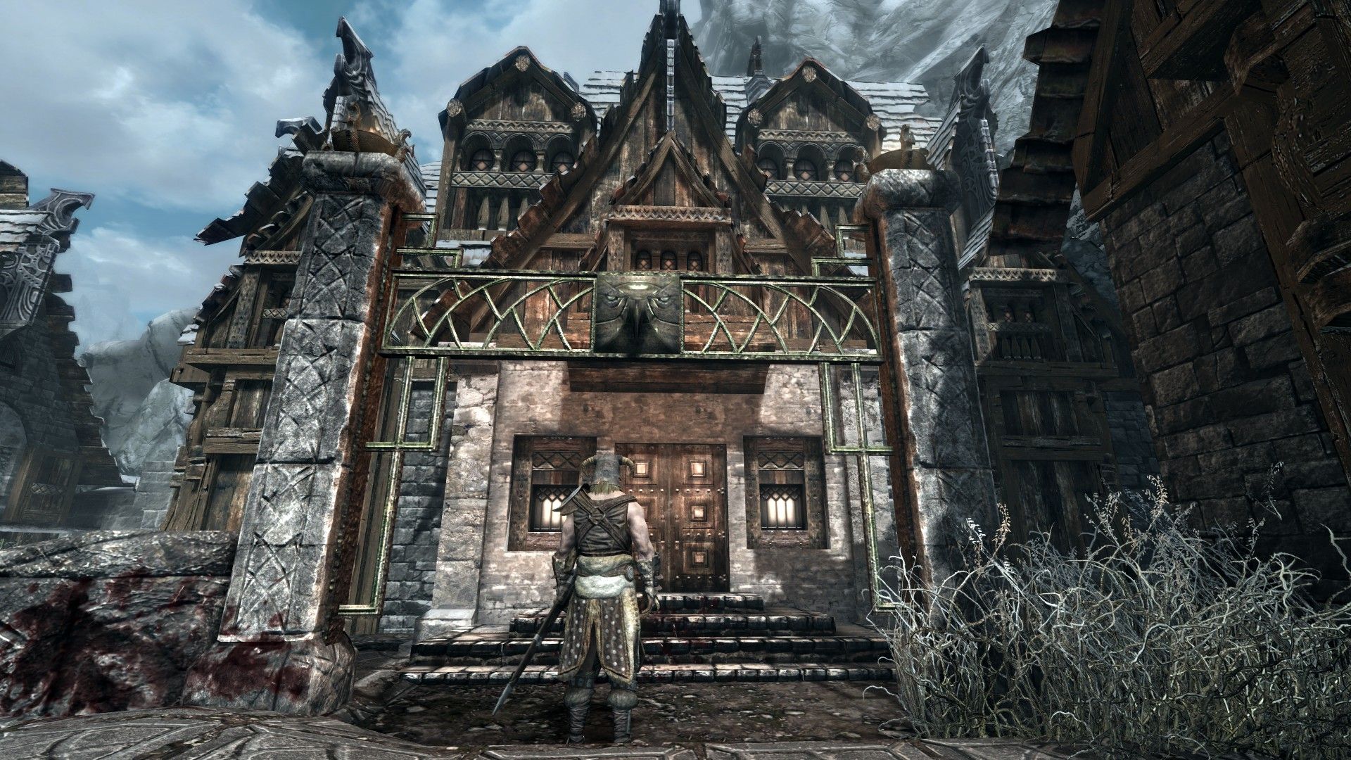 An adventurer stands in front of a large, ornate house with a trail of blood leading inisde.