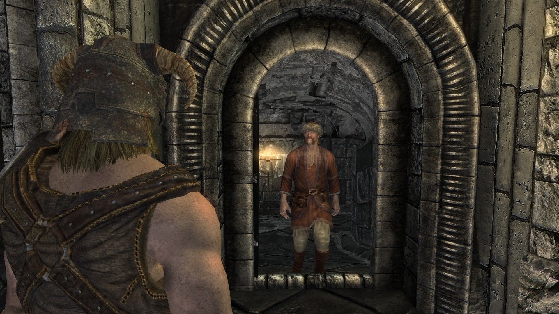 A well-dressed man wearing red clothes emerges from a stone tunnel inside a castle.