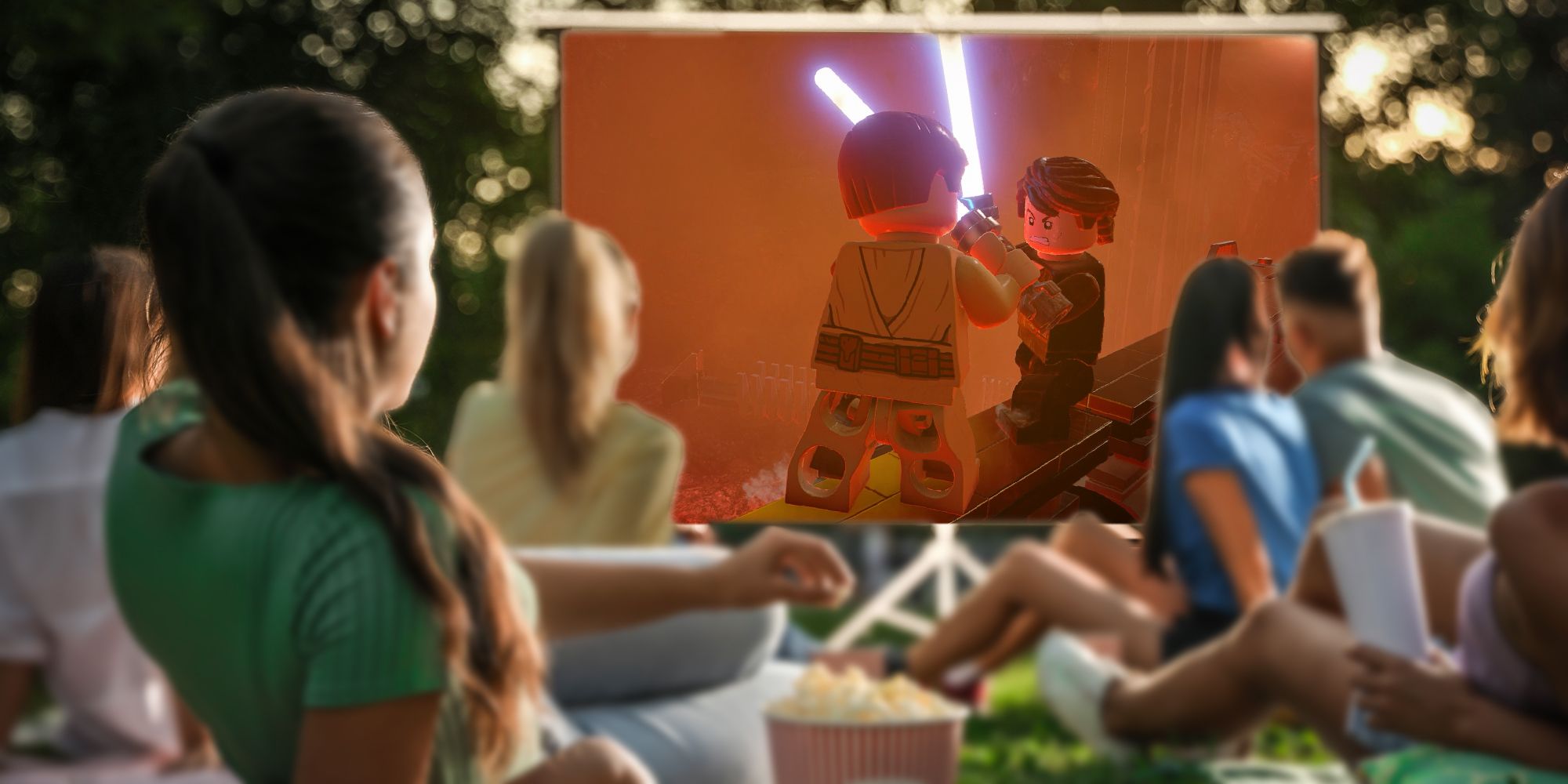 People watching Lego Star Wars: The Skywalker Saga as a movie while seated on a lawn.