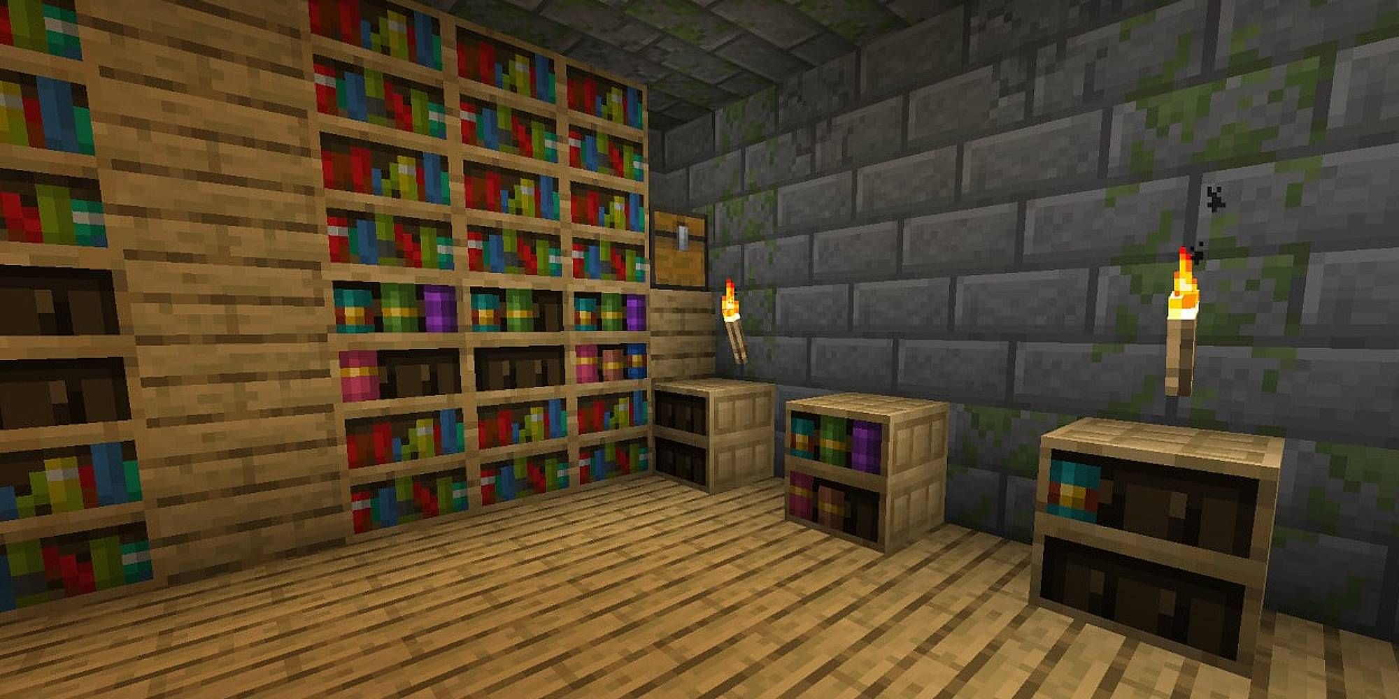 A room full of bookshelves and torches is in a stony room