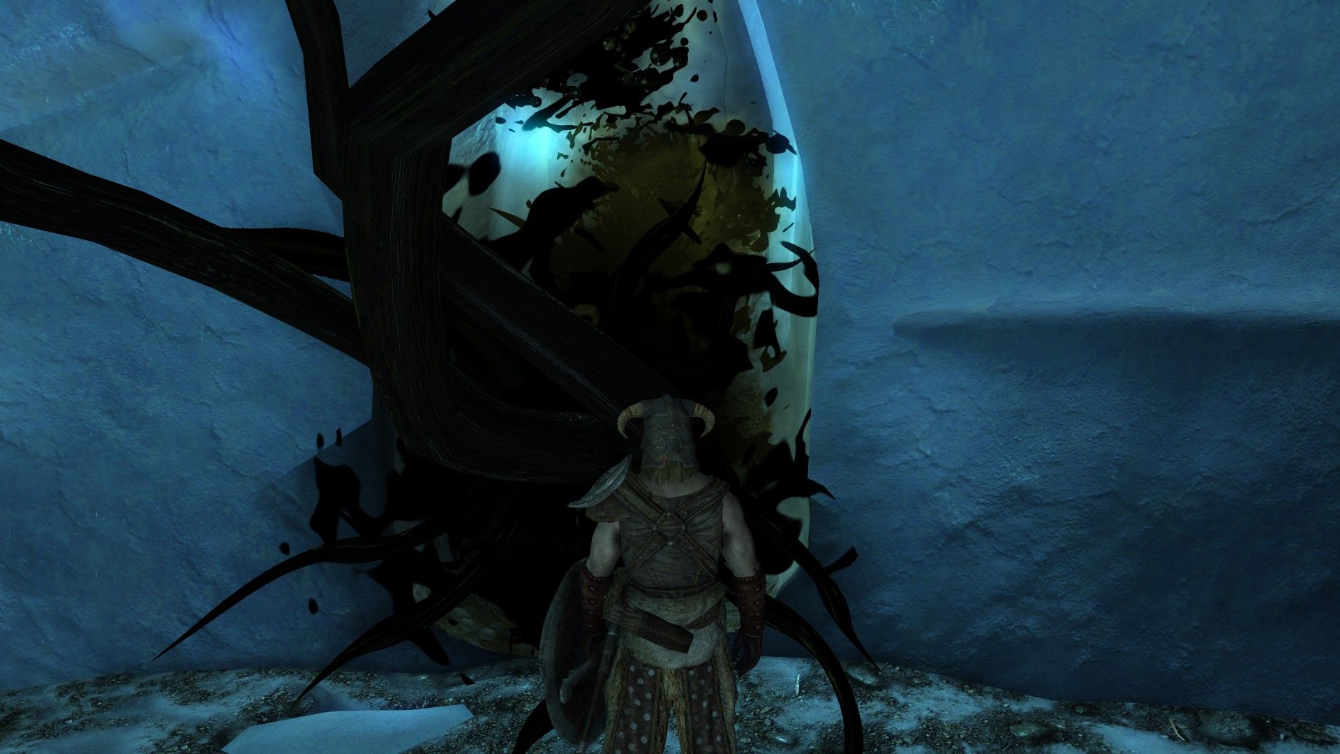 An adventurer stares at a writhing mass of black tentacles emerging from the exit of a frozen cave.