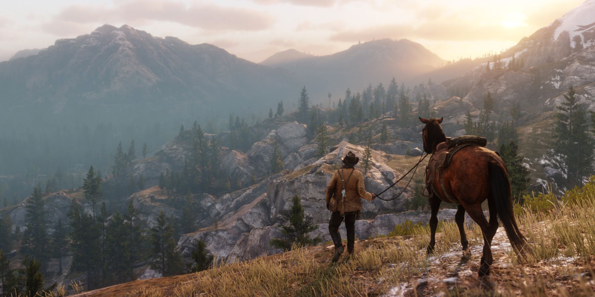 Arthur leading his horse on the top of a hill overlooking a mountainous landscape in Red Dead Redemption 2