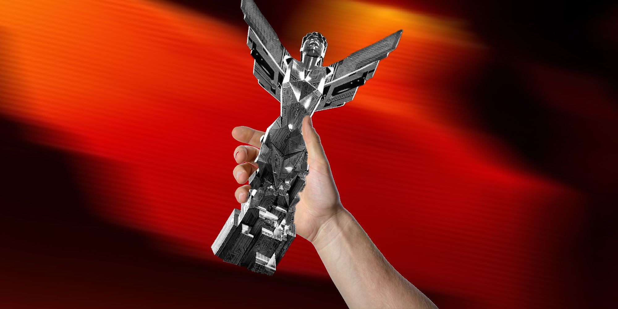 a hand holding up The Game Award statue
