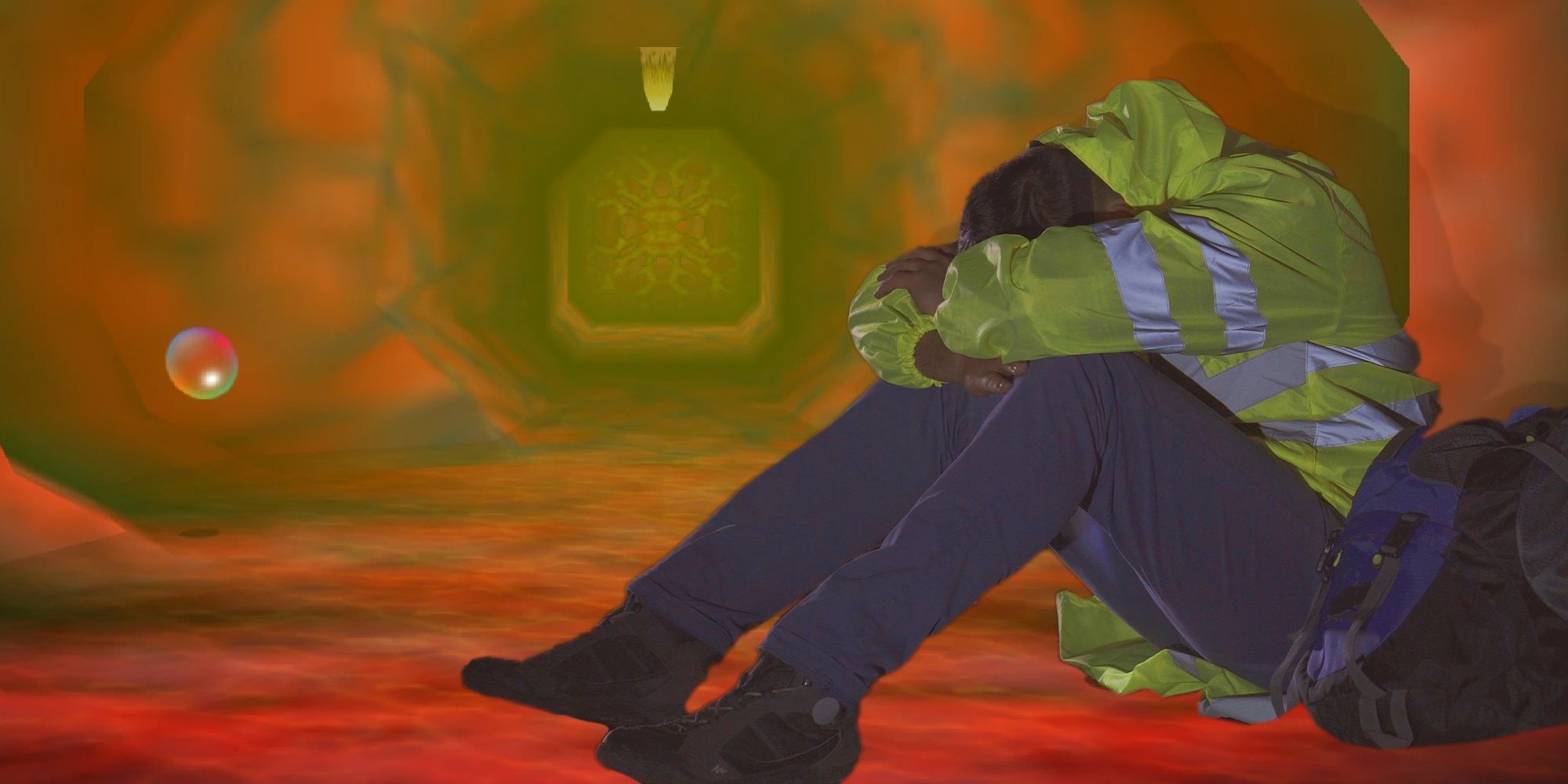 A person in a neon yellow jacket with their head in their arms sitting in a tunnel in Jabu-Jabu's Belly from The Legend of Zelda: Ocarina of Time.