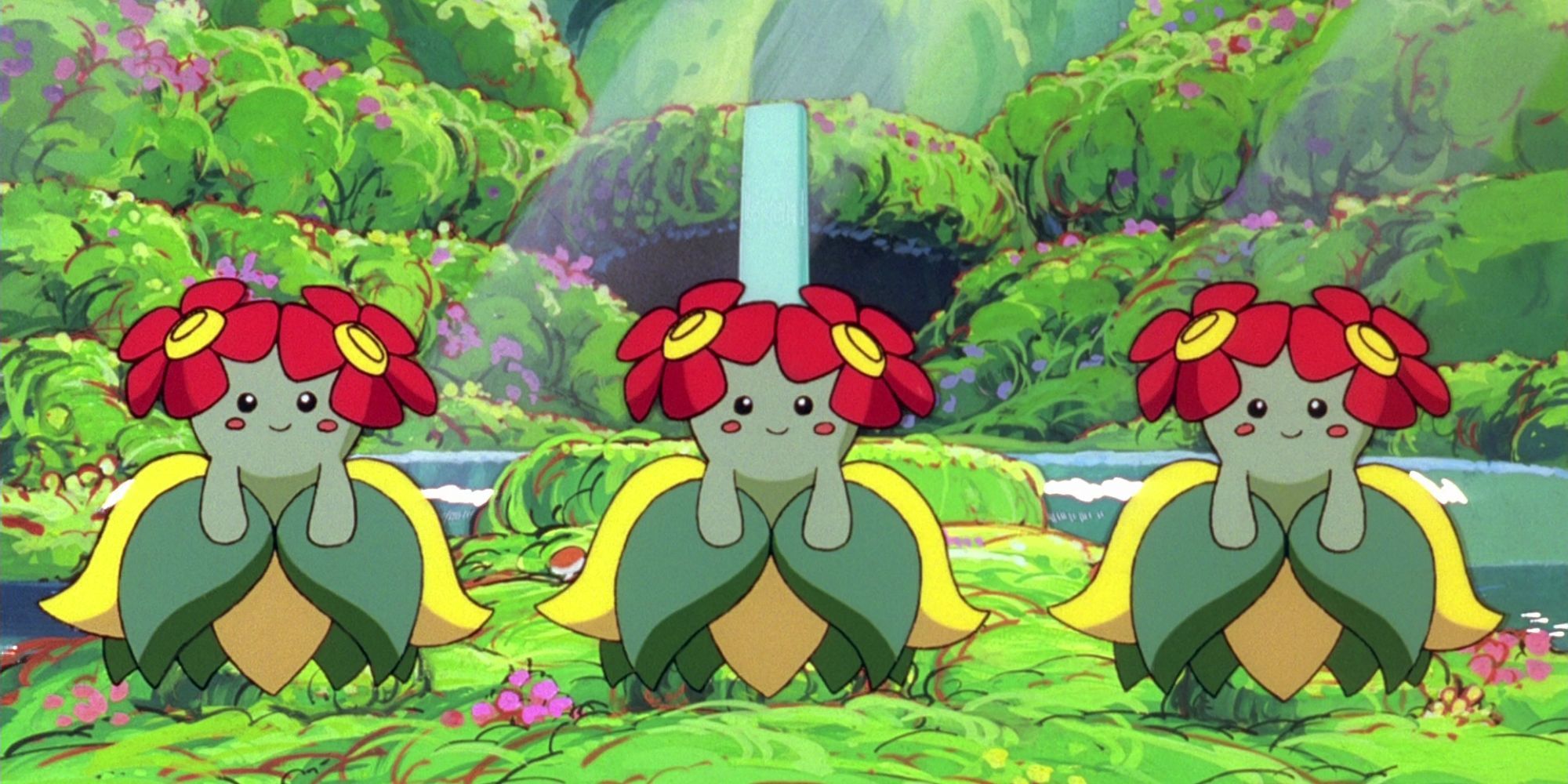 Three Bellossom stand together in front of a waterfall