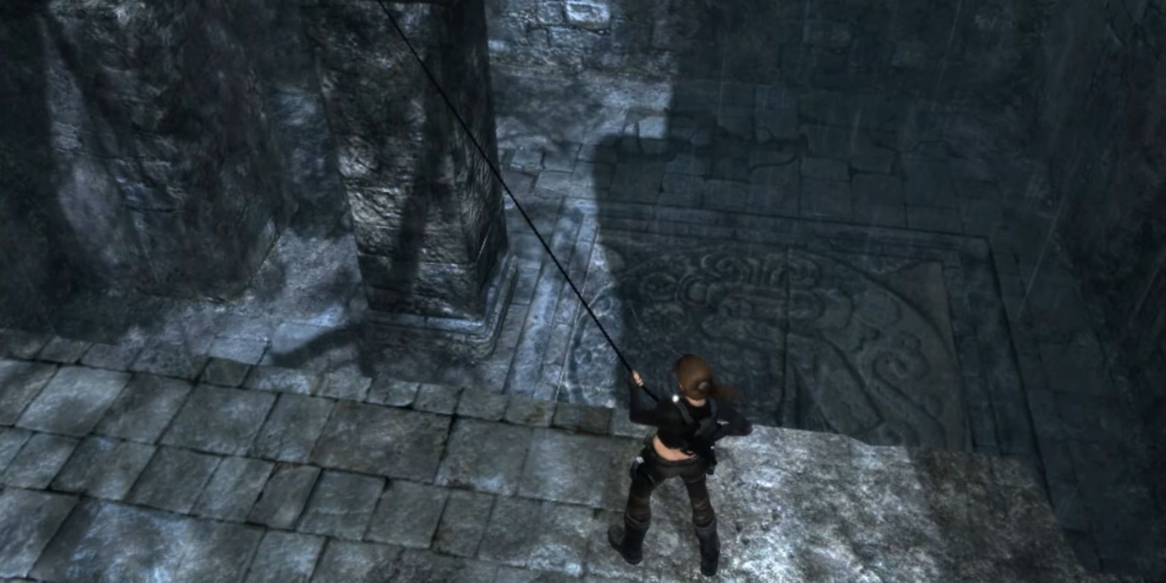 Lara using a grappling hook to move a platform in Tomb Raider: Underworld.