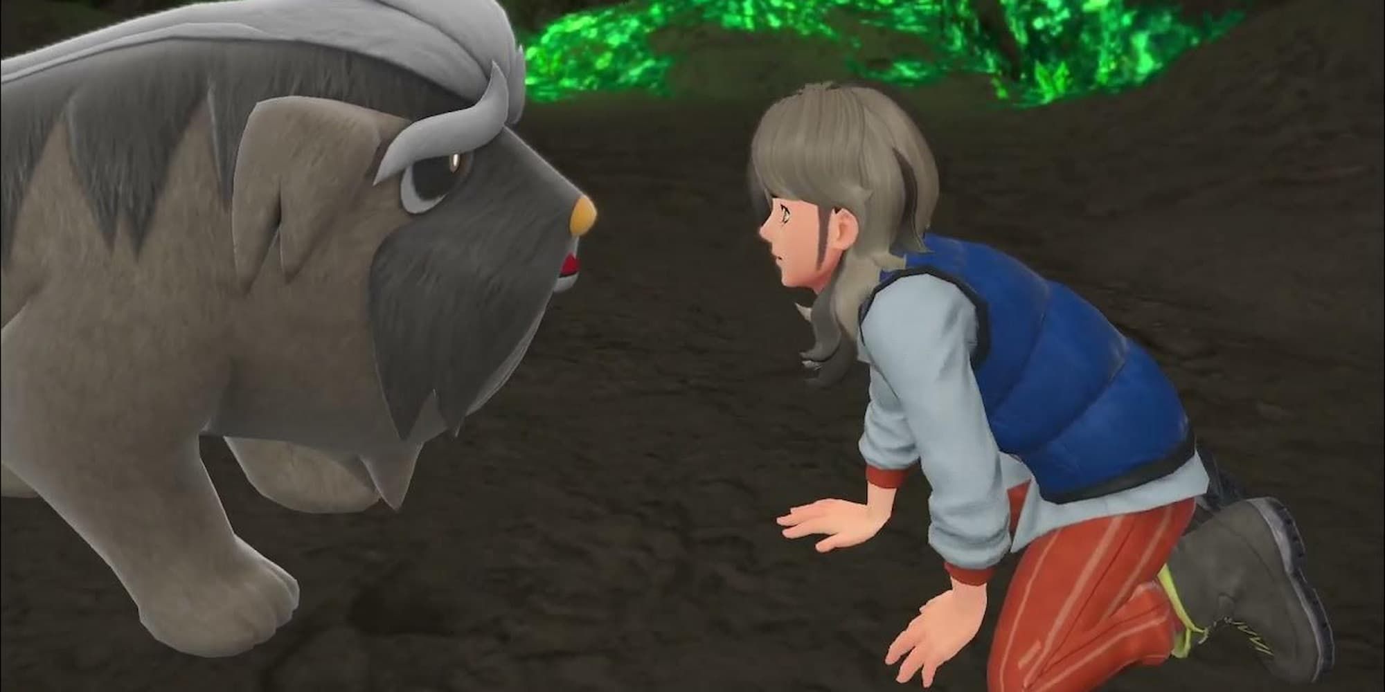 Arven kneels in front of his Mabosstiff in a cave in Pokemon Scarlet & Violet.