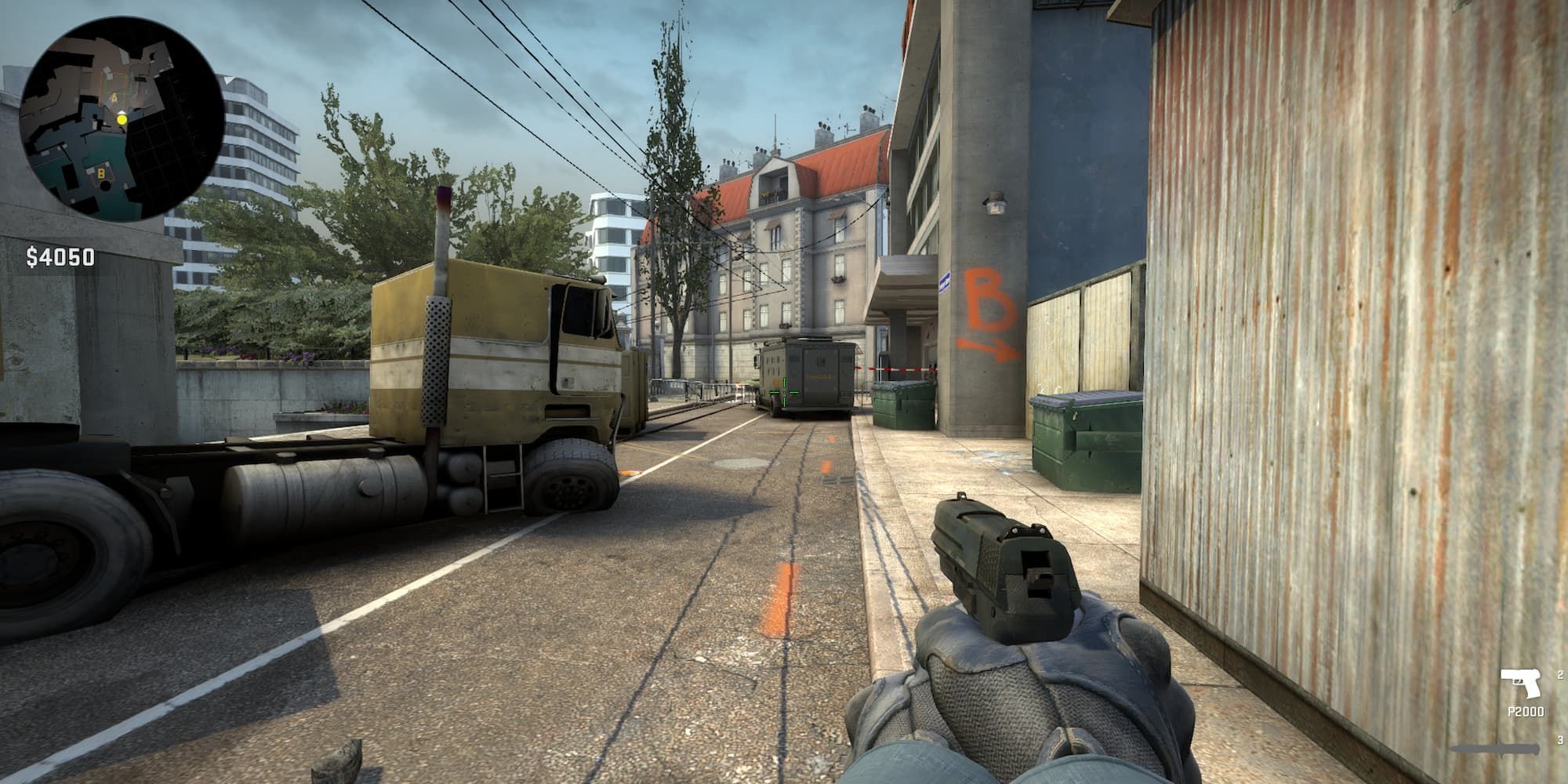 A CS:GO player camps near the broken down truck by A Site on Overpass.