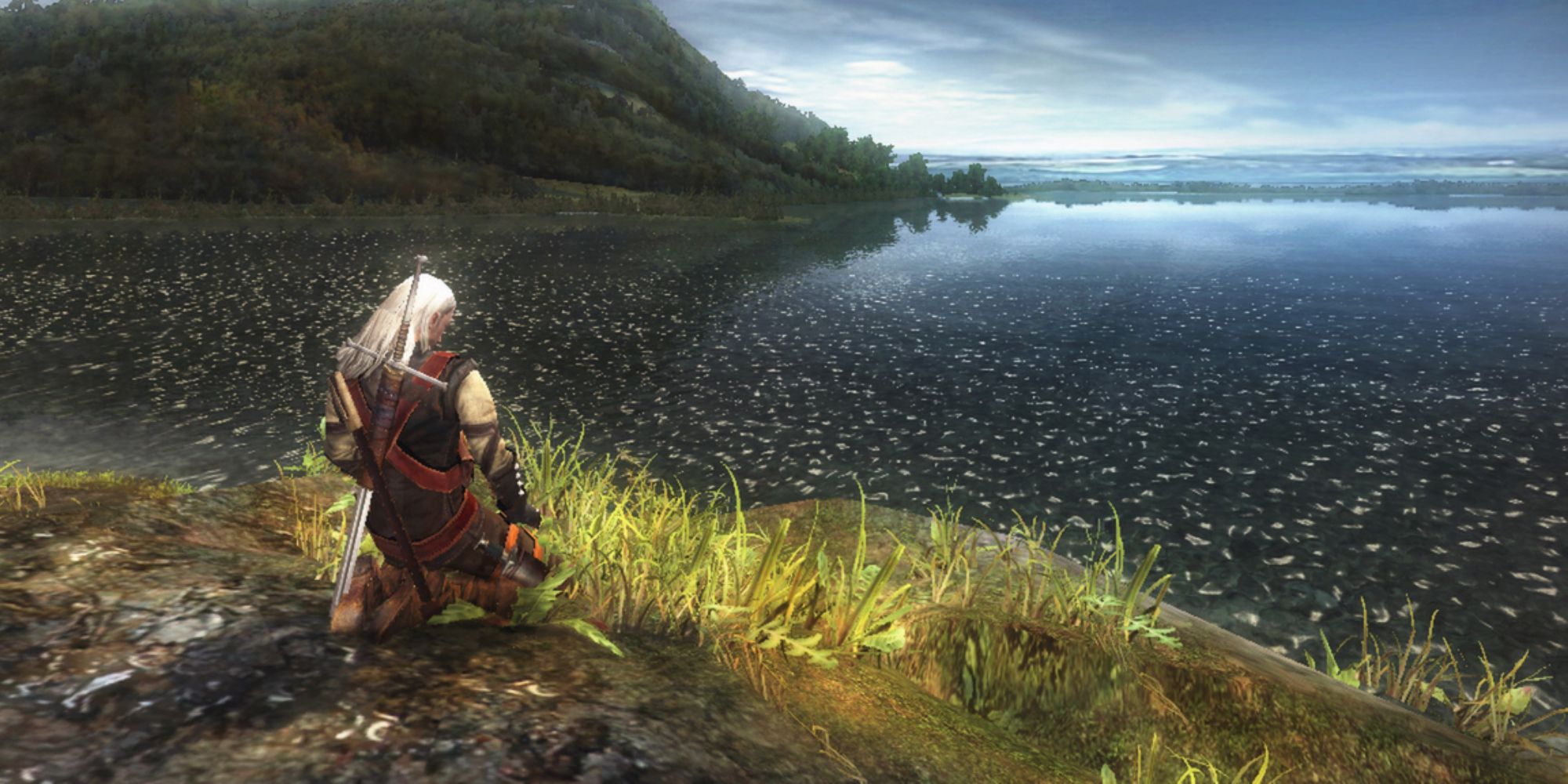 Geralt meditating next to a lake in The Witcher 1