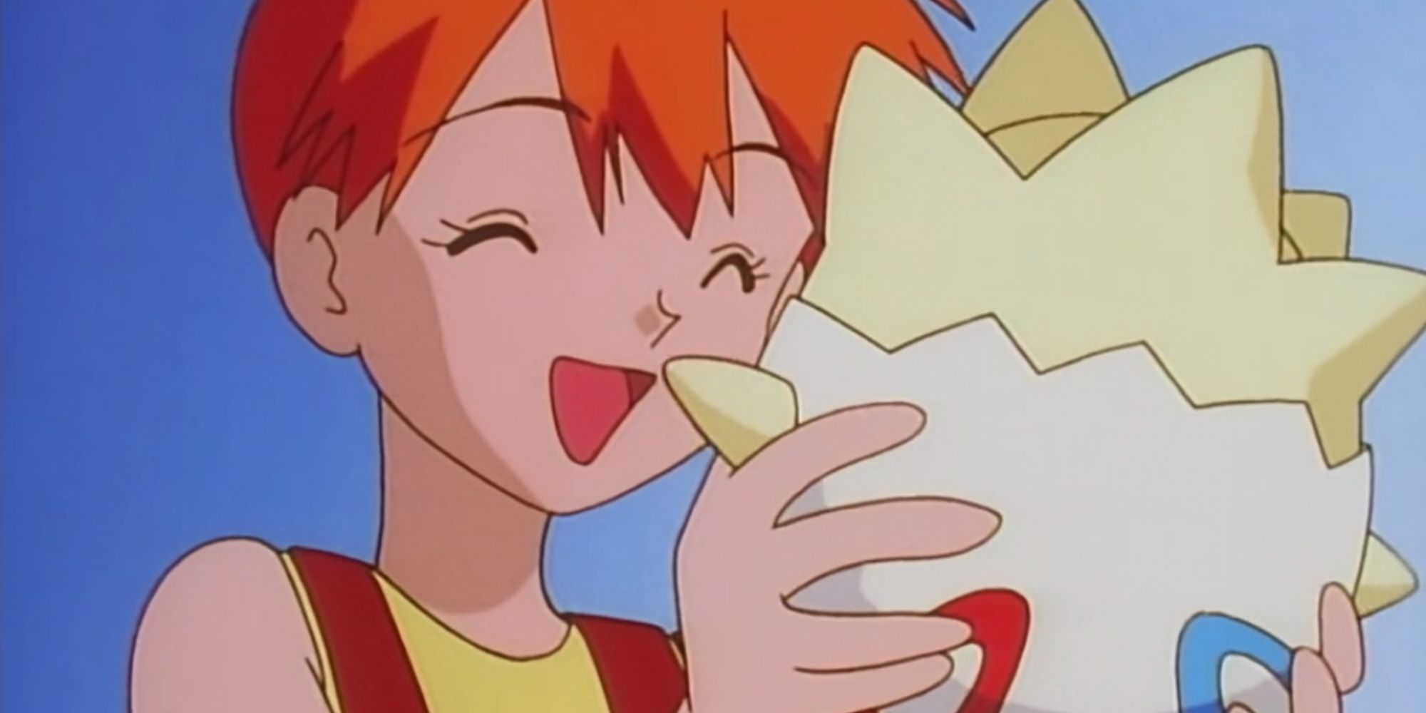 Misty holds Togepi in front of a blue sky in the Pokemon Anime.