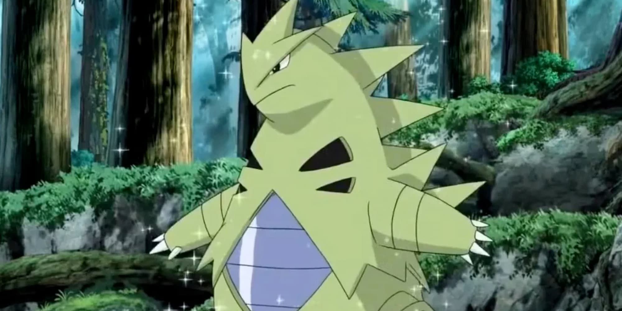 Tyranitar stands in a forest with a bit of a glimmer to it.