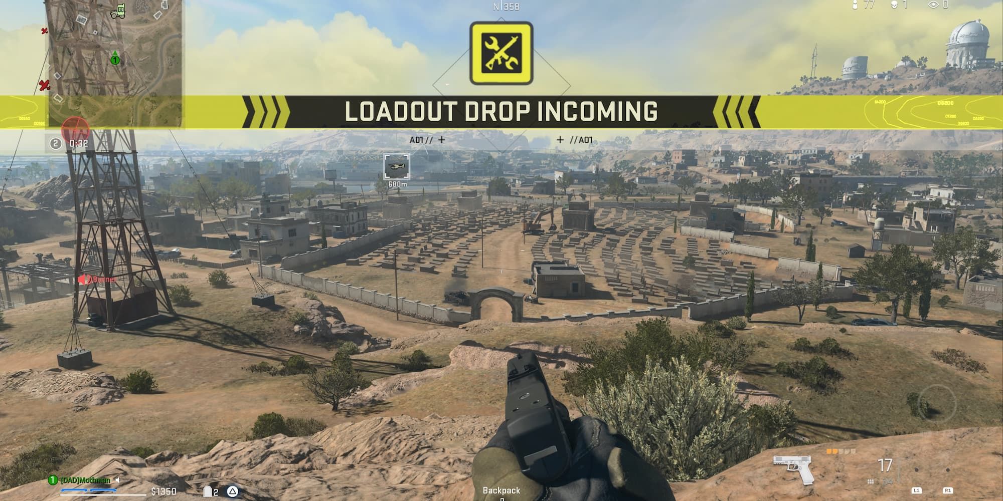 A loadout drop is signaled as a player goes prone on a hill outside of the Al Samman Cemetery.