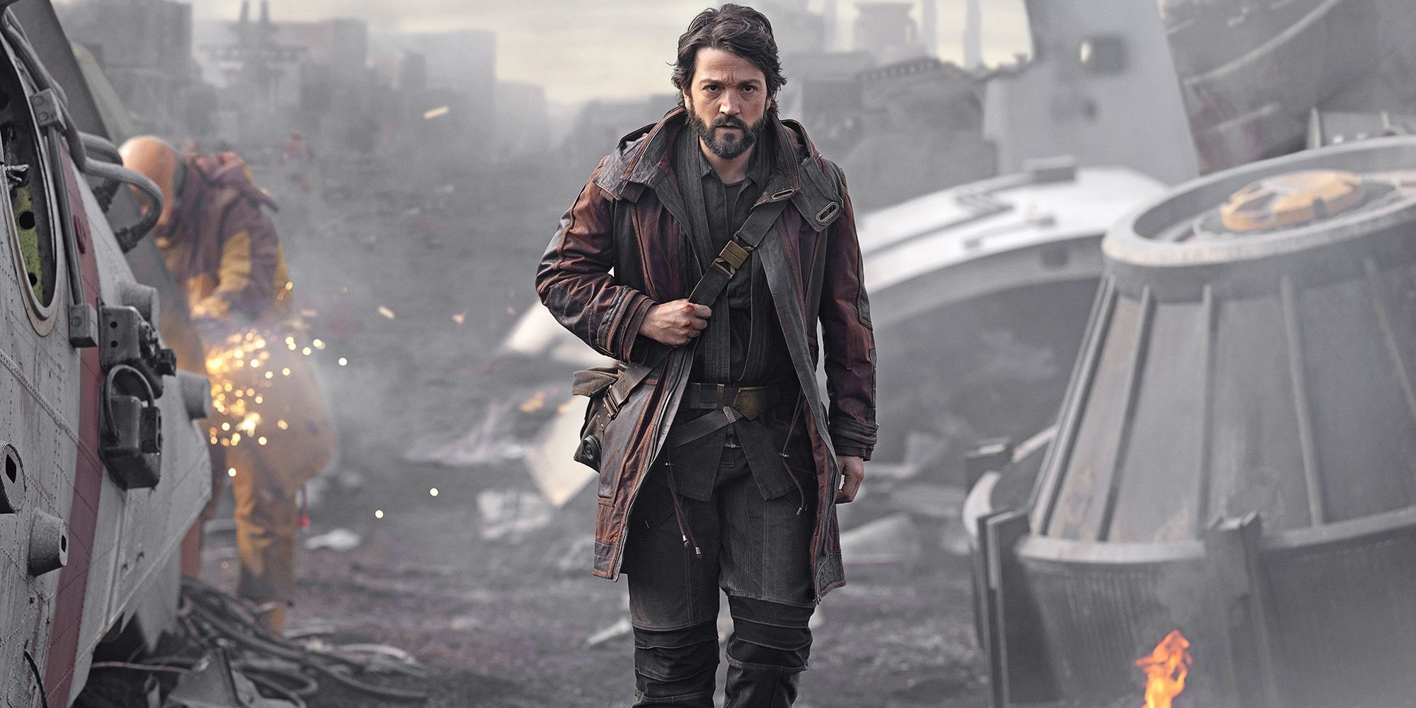 Cassian walking through shipyard in Andor