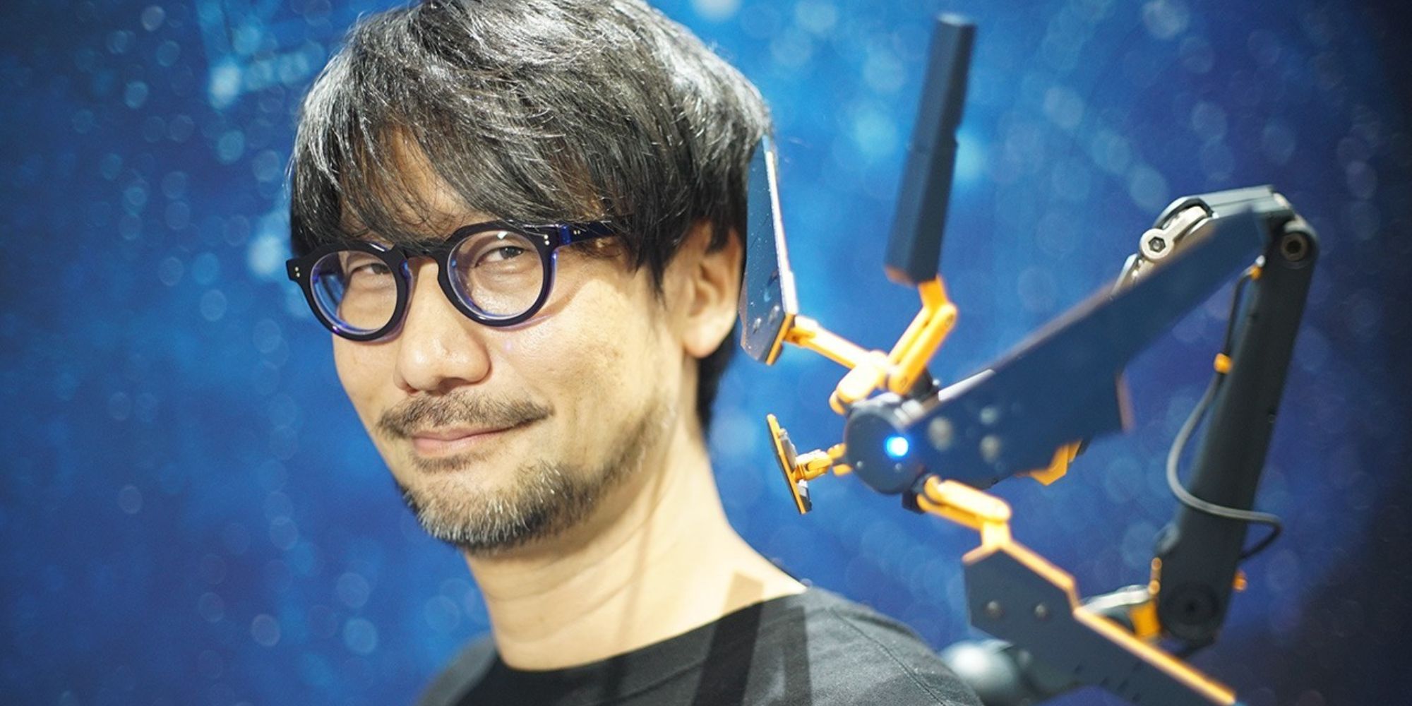 Hideo Kojima donning a gadget from Death Stranding