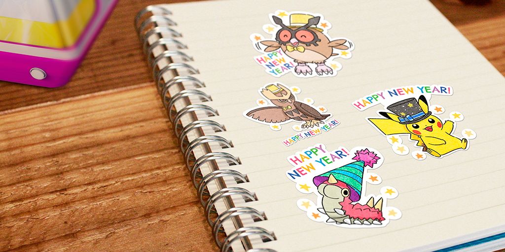 Four different Pokemon Go New Year's 2023 Stickers on a notebook page