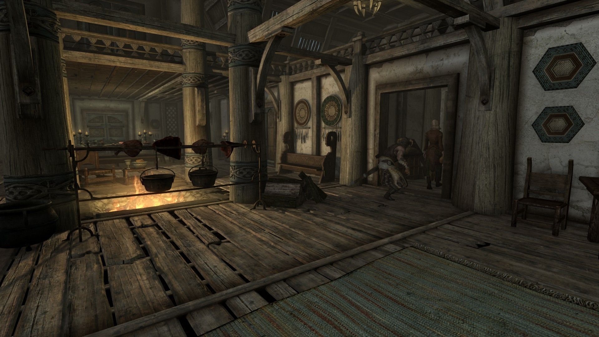 An adventurer sneaks through a wooden house with a roaring fireplace in the middle.