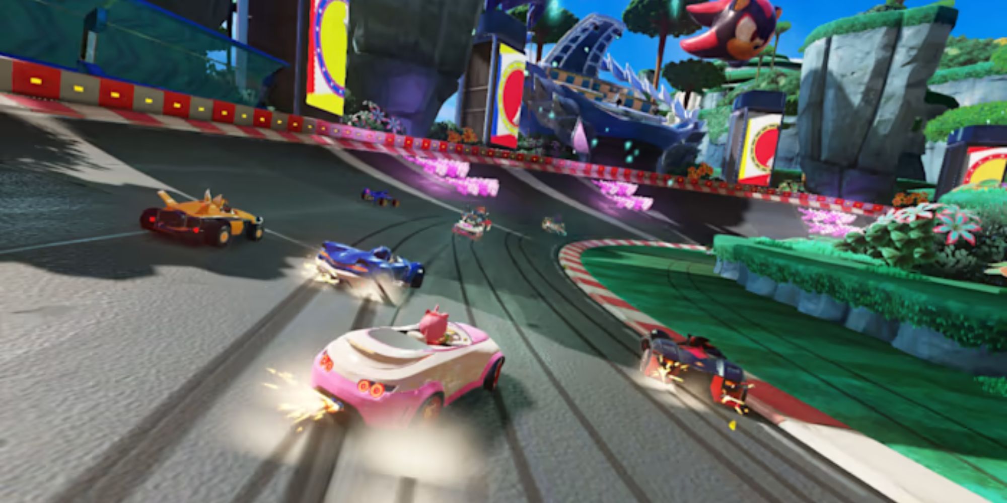 Amy drifts behind Shadow, Sonic, and Tails on a racetrack