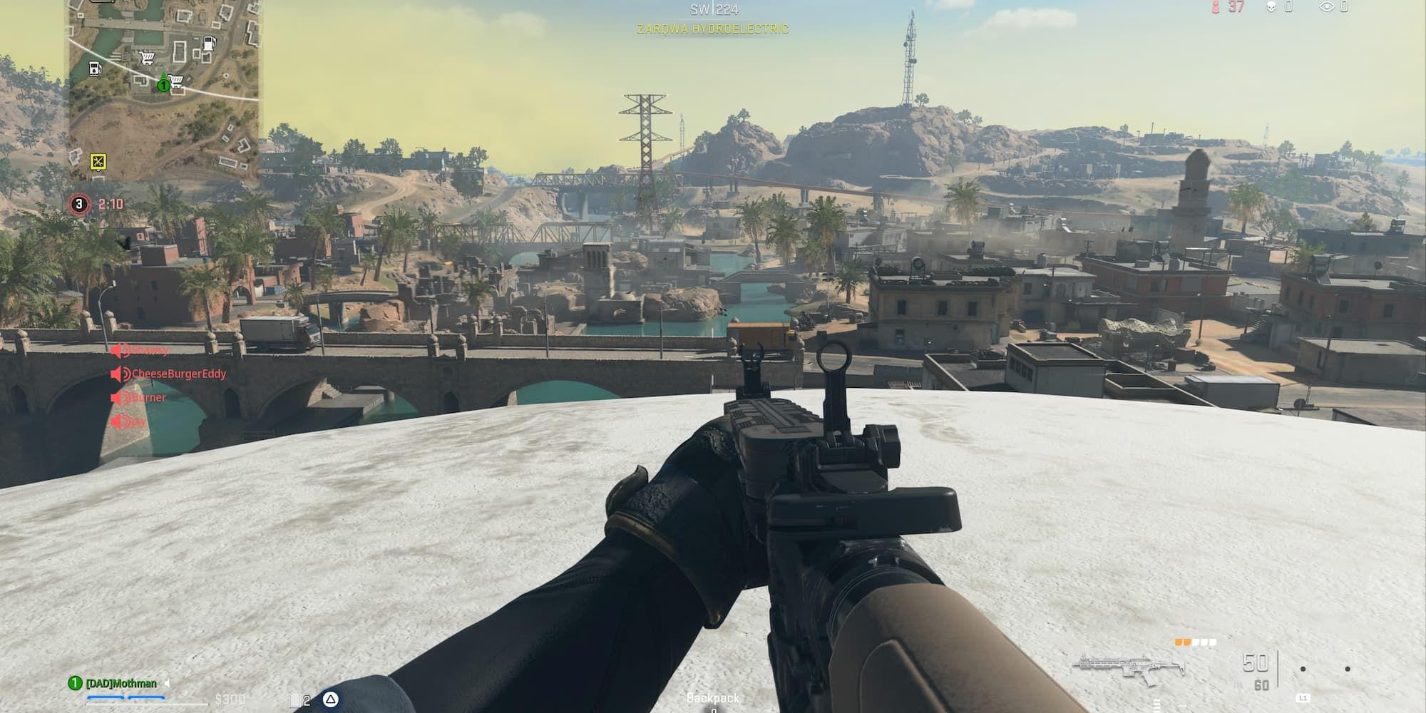 The player and his assault rifle look at the bridge of Zarqwa Hydroelectric from the top of the water tower.