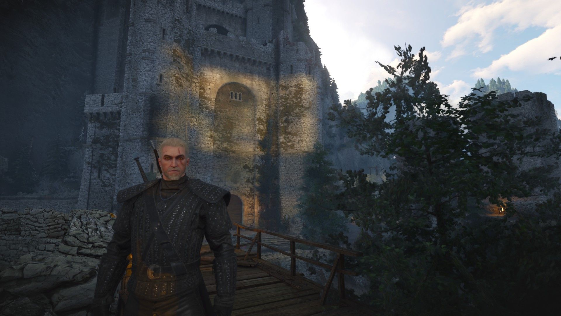 Geralt standing in front of Kaer Morhen in the Full Forgotten Wolven School Gear Set.