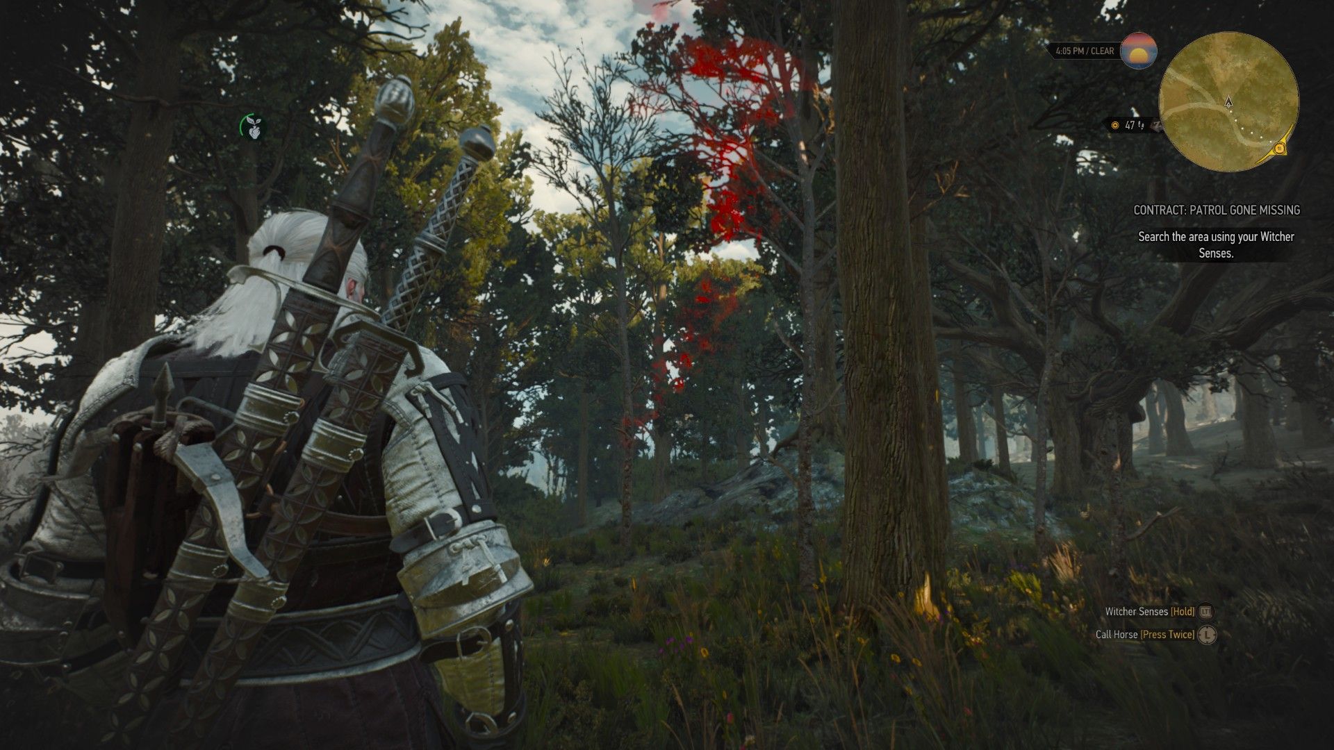 A screenshot of Geralt picking up a scent while following a trail of footsteps through a forest.
