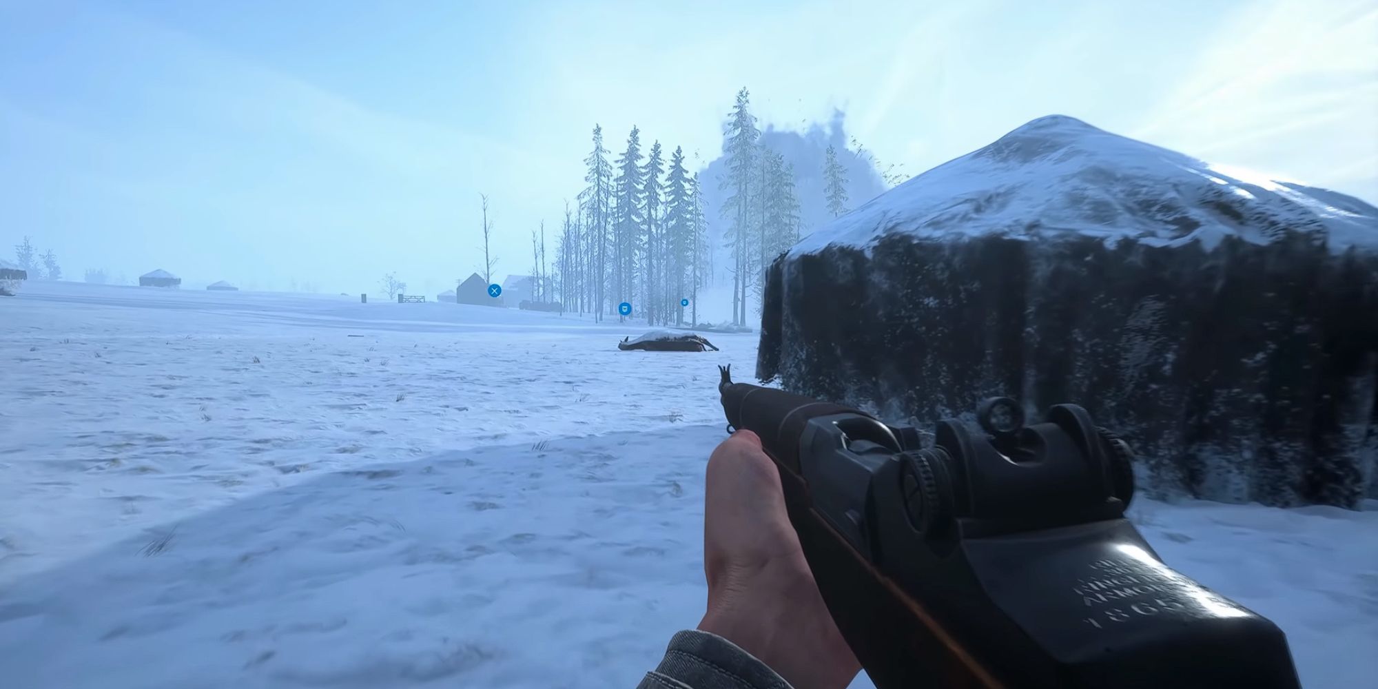 Player holds M1 Garand in Hell Let Loose while going through the snow as smoke rises from trees in the distance