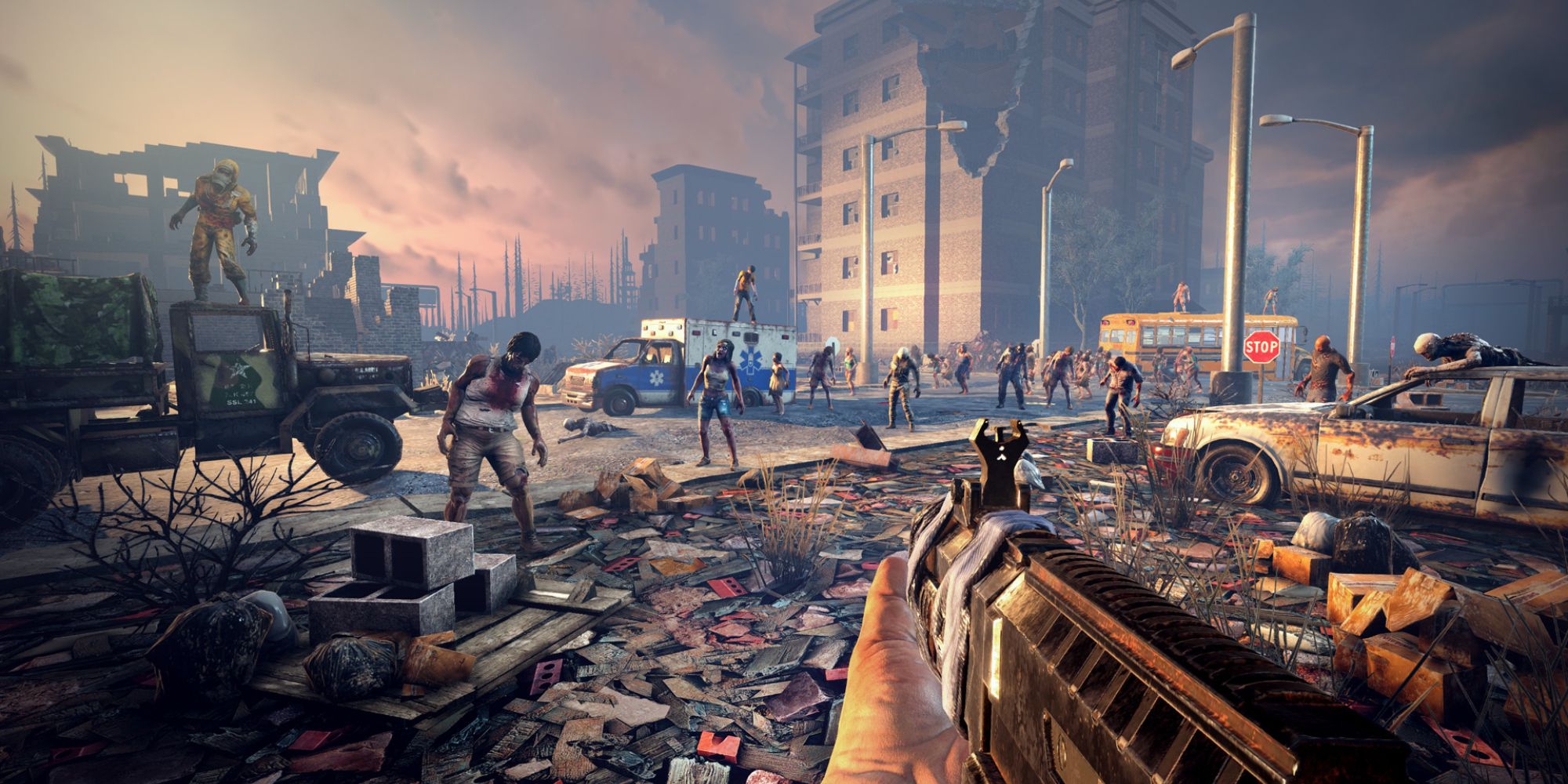 First person perspective holding a machine gun with a horde of zombies ahead