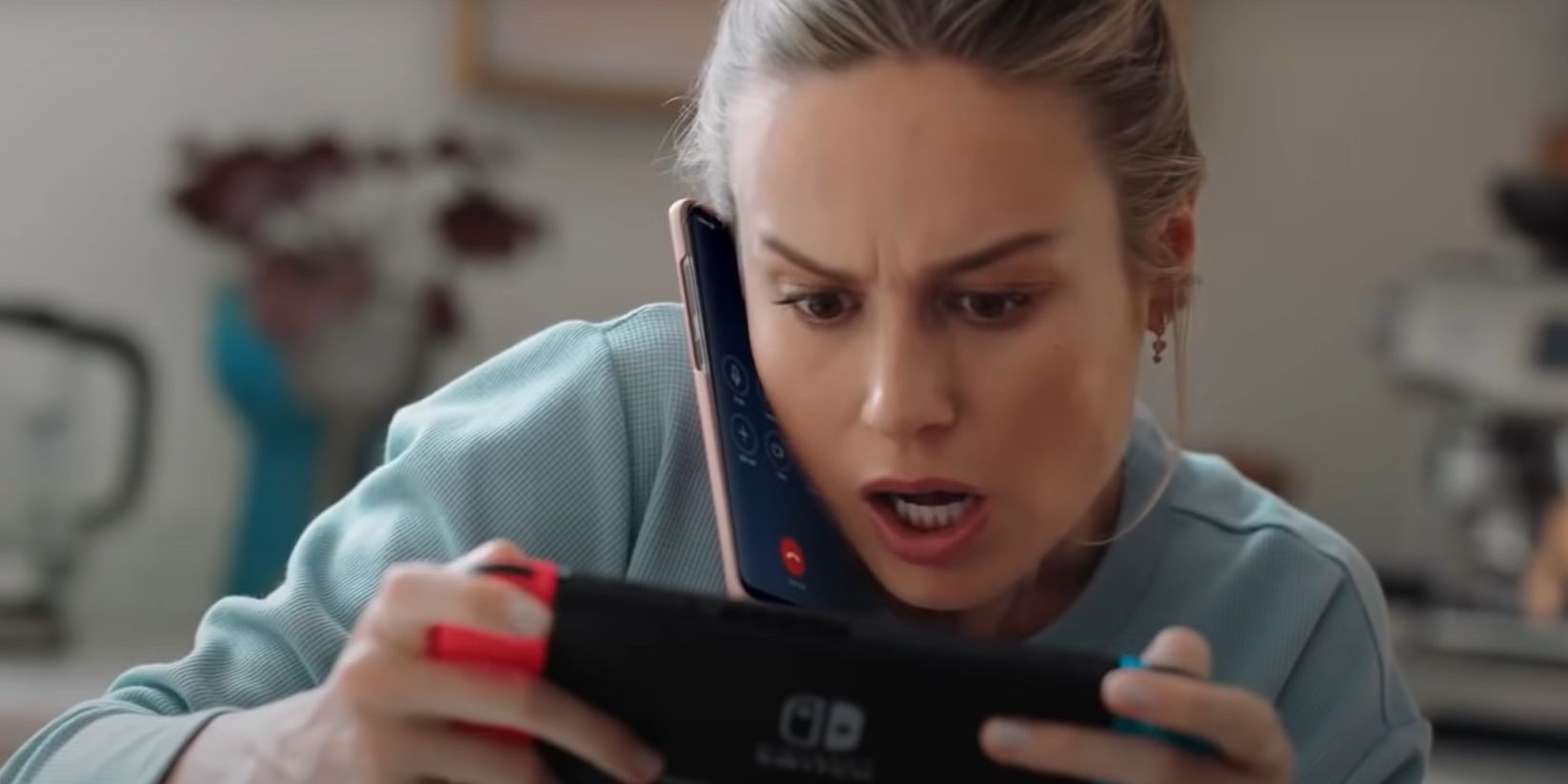 Brie Larson playing on a Nintendo Switch while on the phone in Nintendo Switch commercial