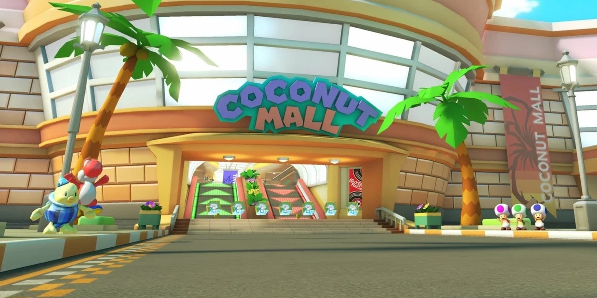 The front of Coconut Mall shows escalators up into the mall, a large sign for the mall, and item blocks at the entrance.