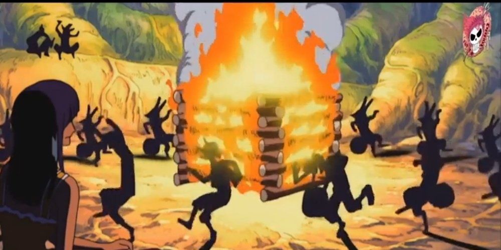 The Straw Hat pirates dance around a bonfire singing in the One Piece anime