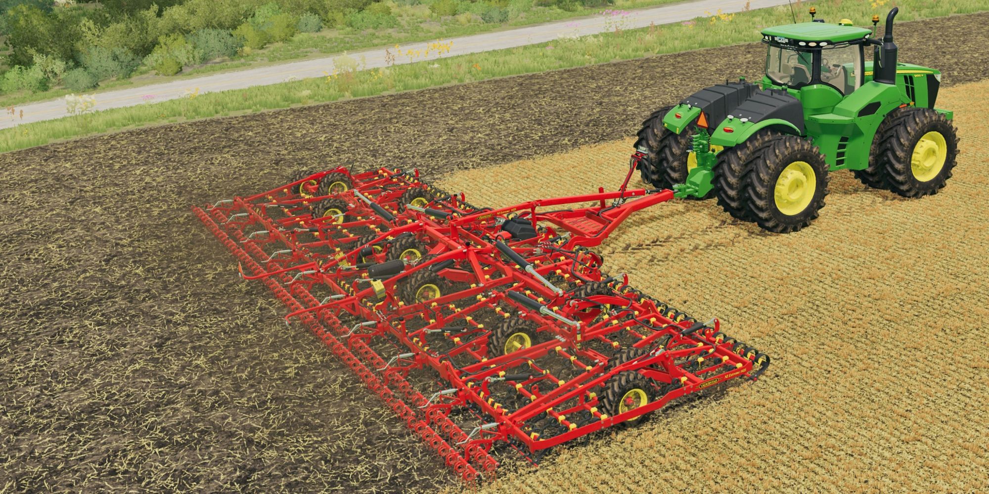 A tractor pulling a machine that is harvesting the last of the crops in the ground