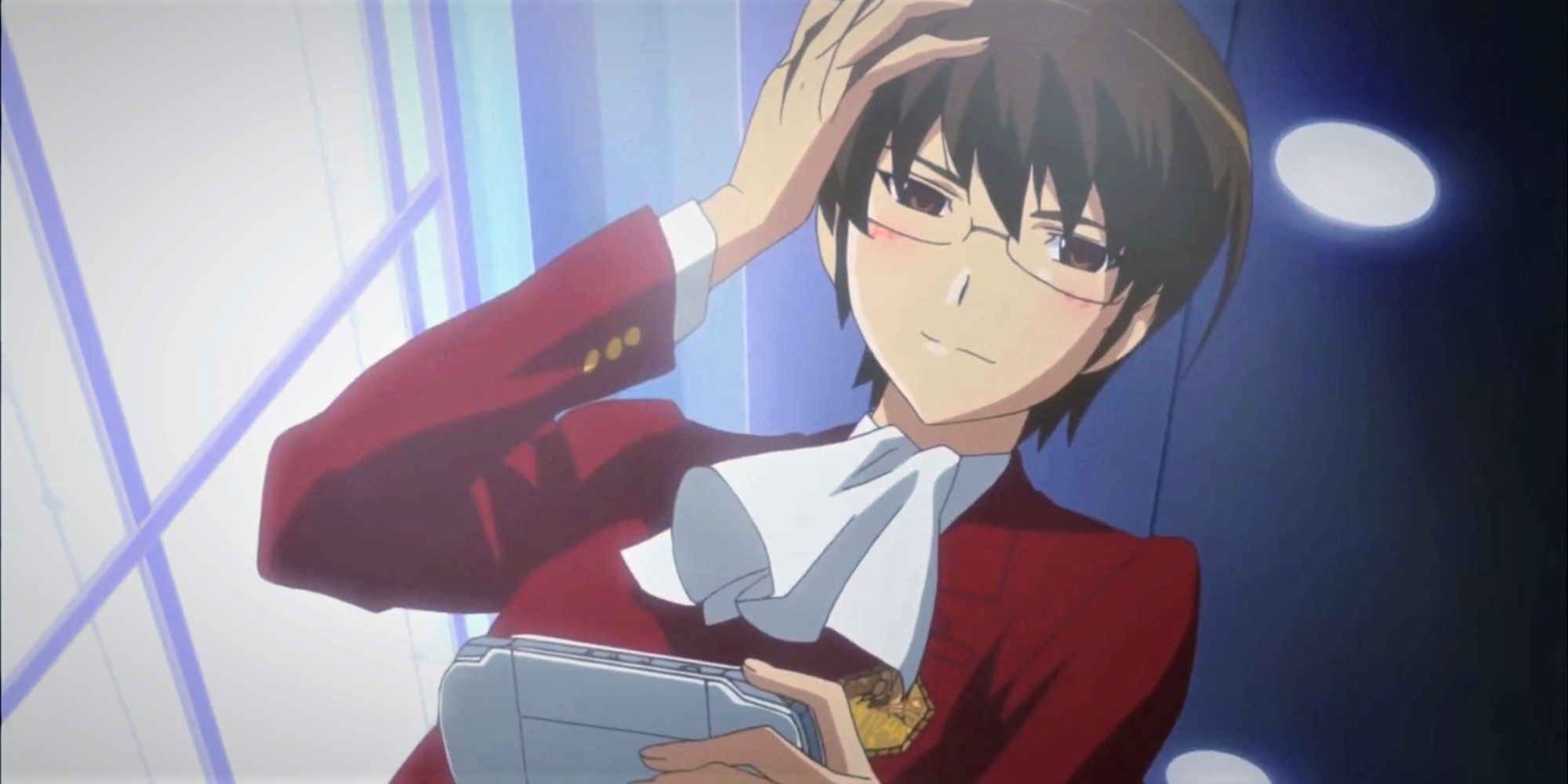 Keima posing while holding his gaming device