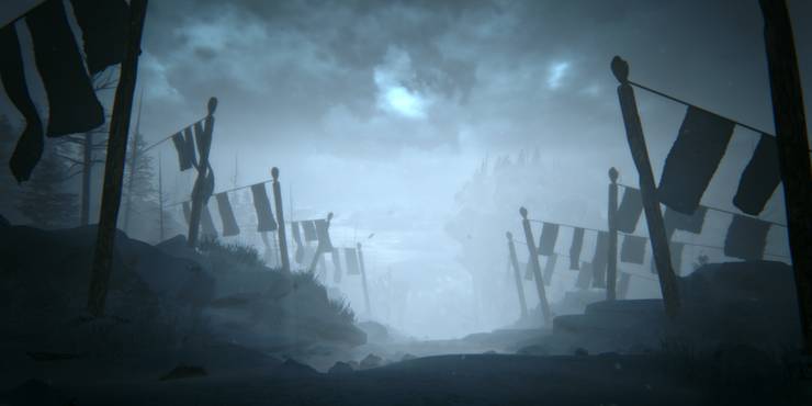 A landscape of a snowy mountain trail at night and trail flags on the sides in Kholat