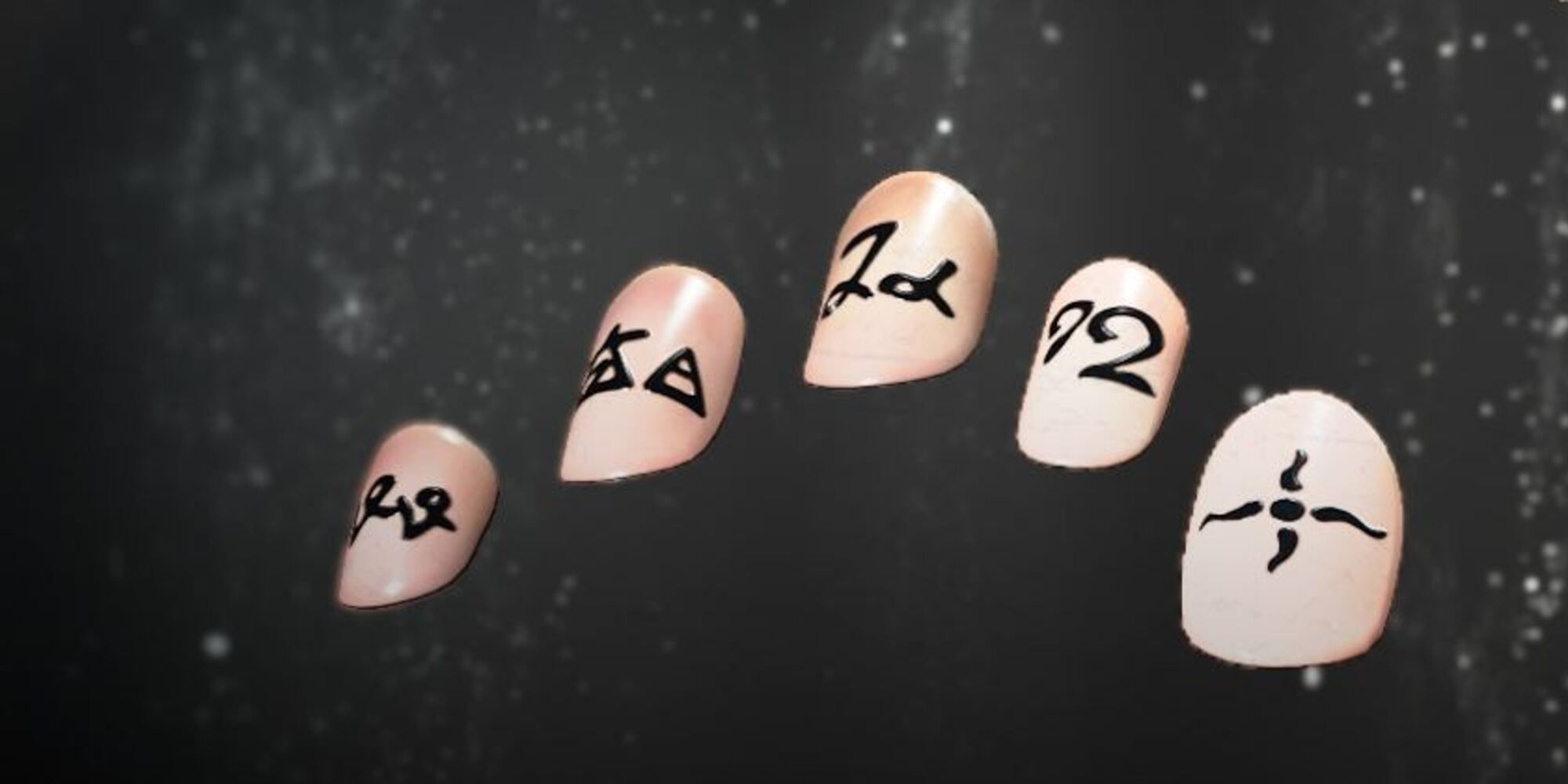 Image of a nail set, light peach with writing in another language layered on top as a nail design.