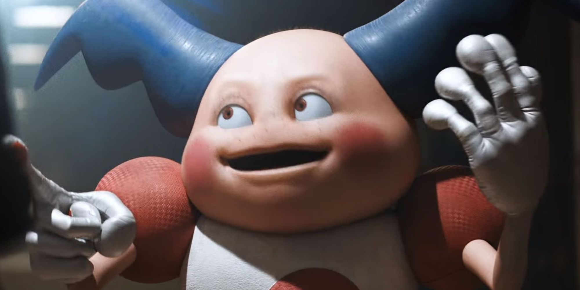 Mr. Mime stands in a dark room and points to the front