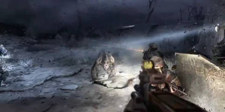 Artyom beside a fellow ranger, aiming his weapon at a watcher that's charging at him with full force in Metro 2033.