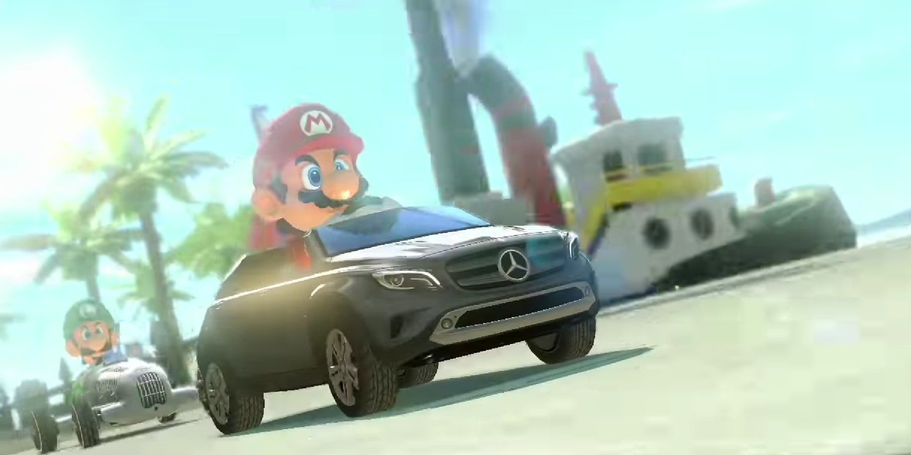 Mario and Luigi racing on a beachside track in Mercedes-Benz karts, with Mario on the GLA and Luigi on the W25.