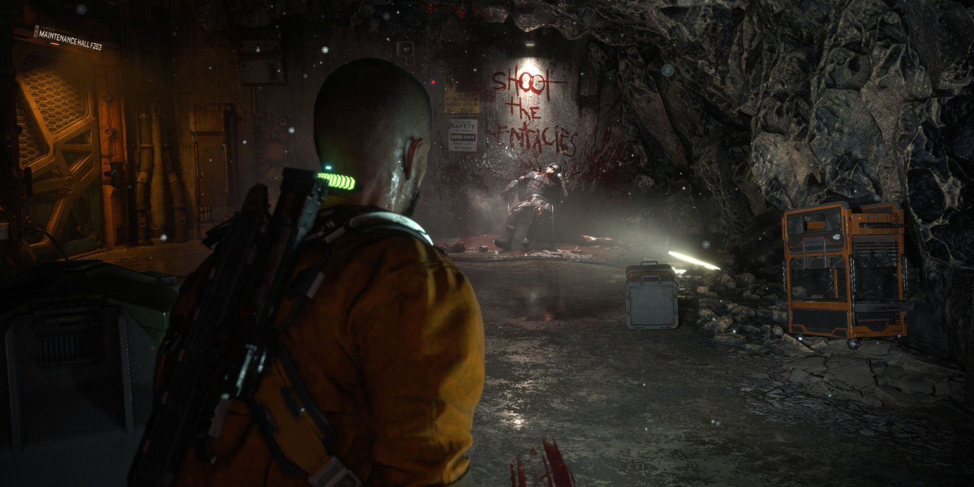 An screenshot from The Callisto Protocol showing the protagonist in a creepy cave