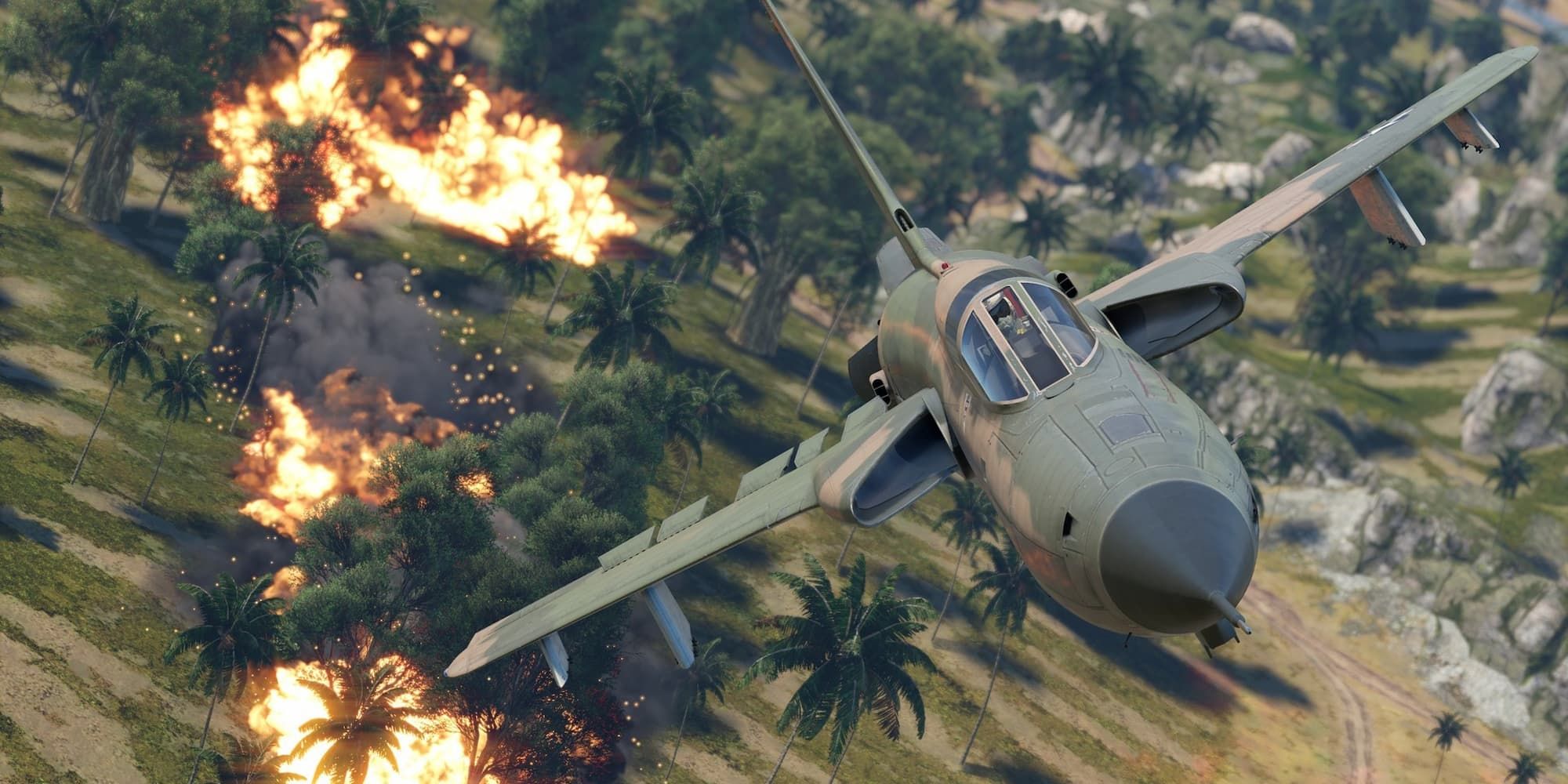A fighter plane flies over palm trees after completing a bombing run in War Thunder.