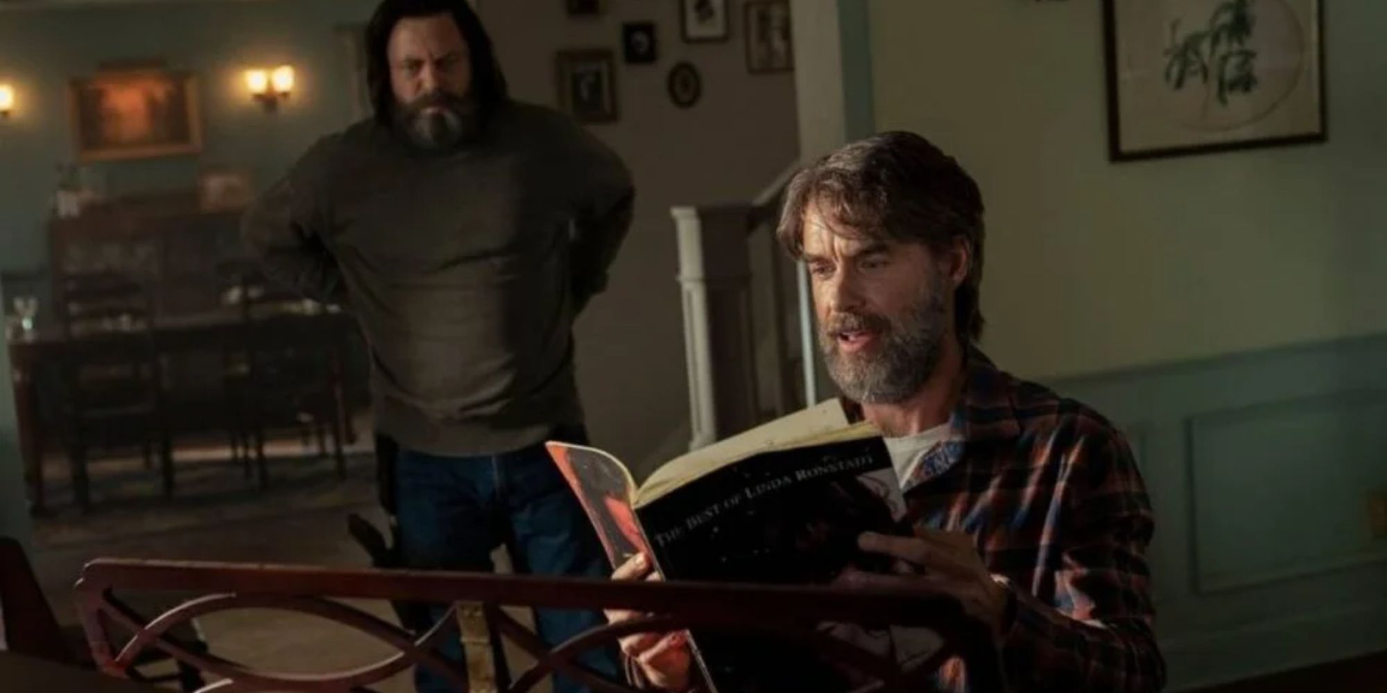 Bill looking at Frank as he looks through the Linda Ronstadt sheet music while sitting by the piano.