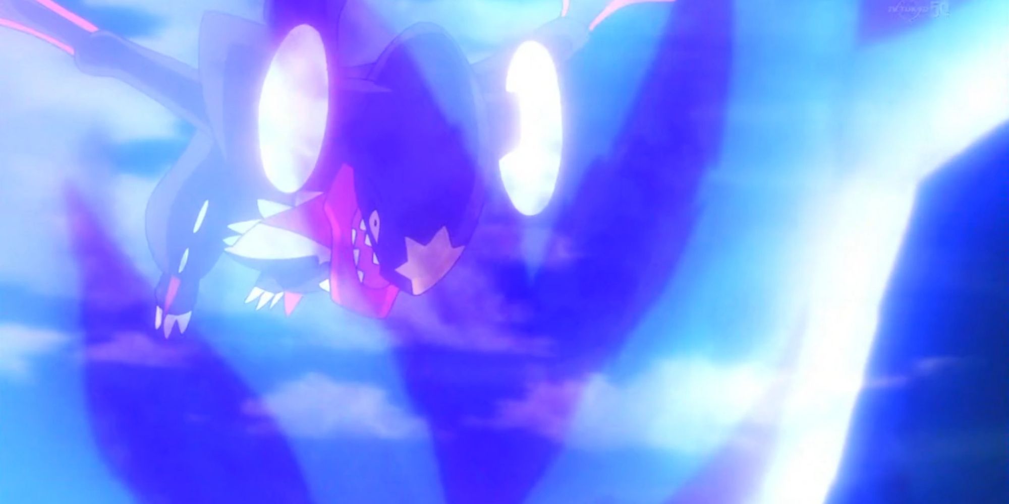 Mega Garchomp Charging Forward While Surrounded By Blue Energy