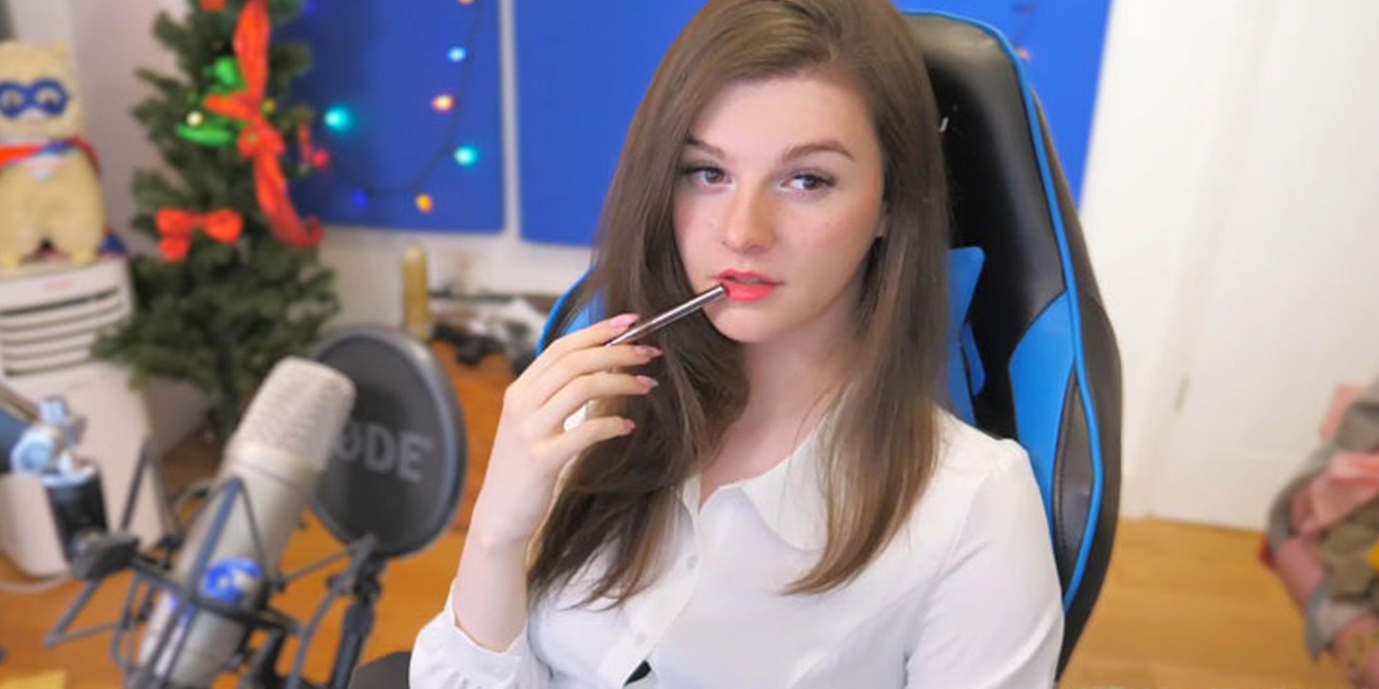 FINNSTER applying lipstick in their gaming chair